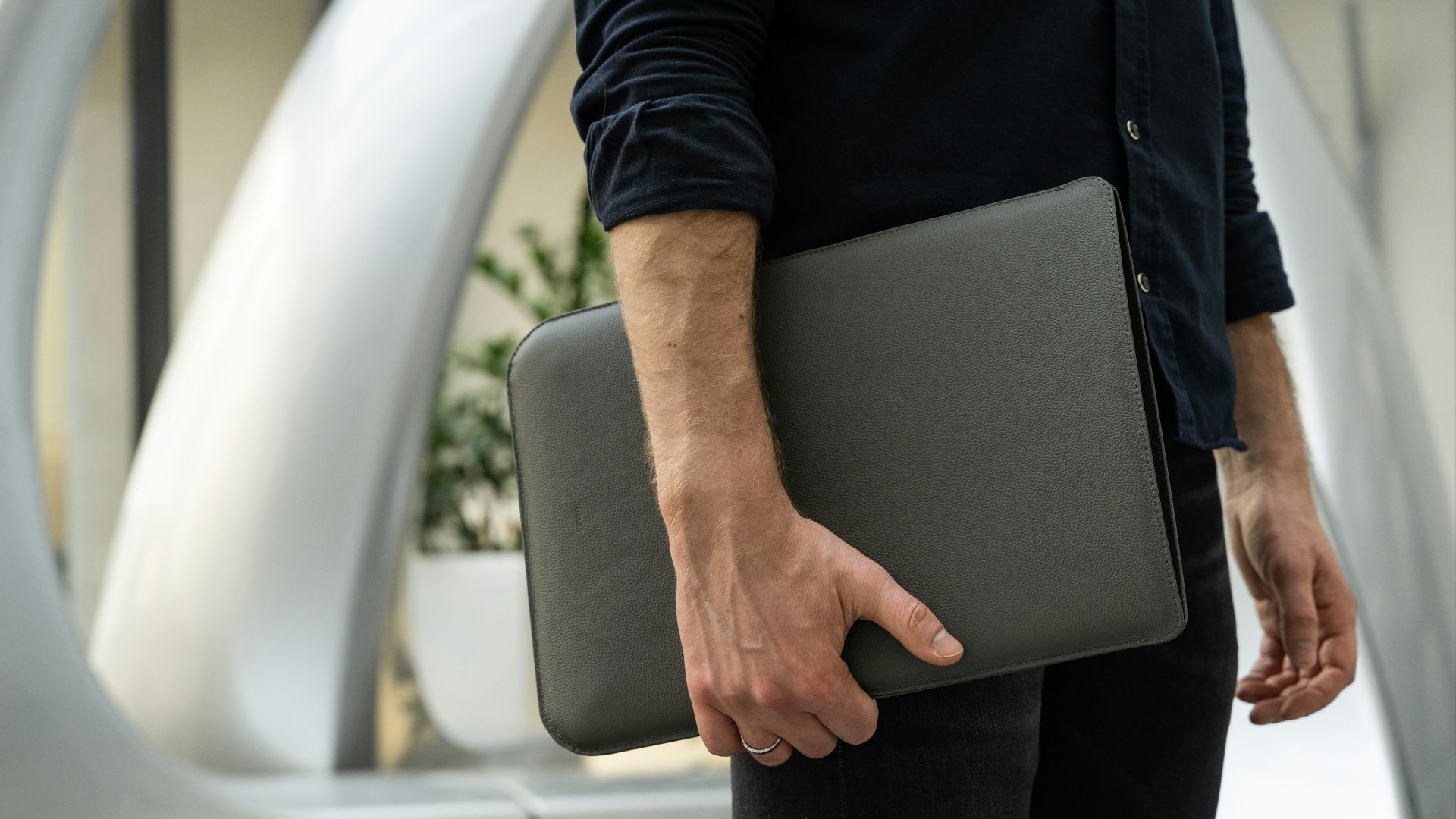 a man holding a laptop in his hand