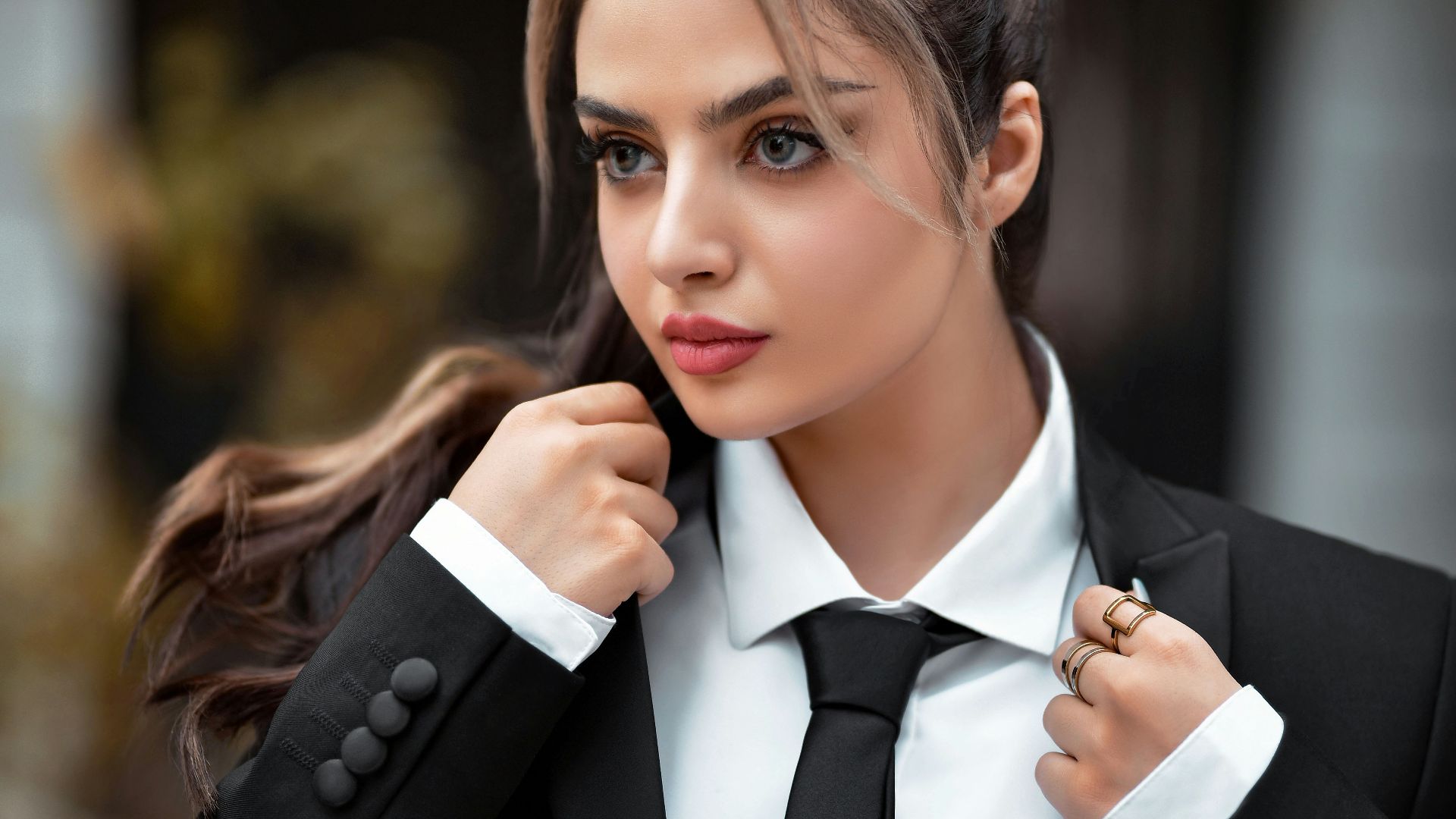 a woman in a suit and tie posing for a picture