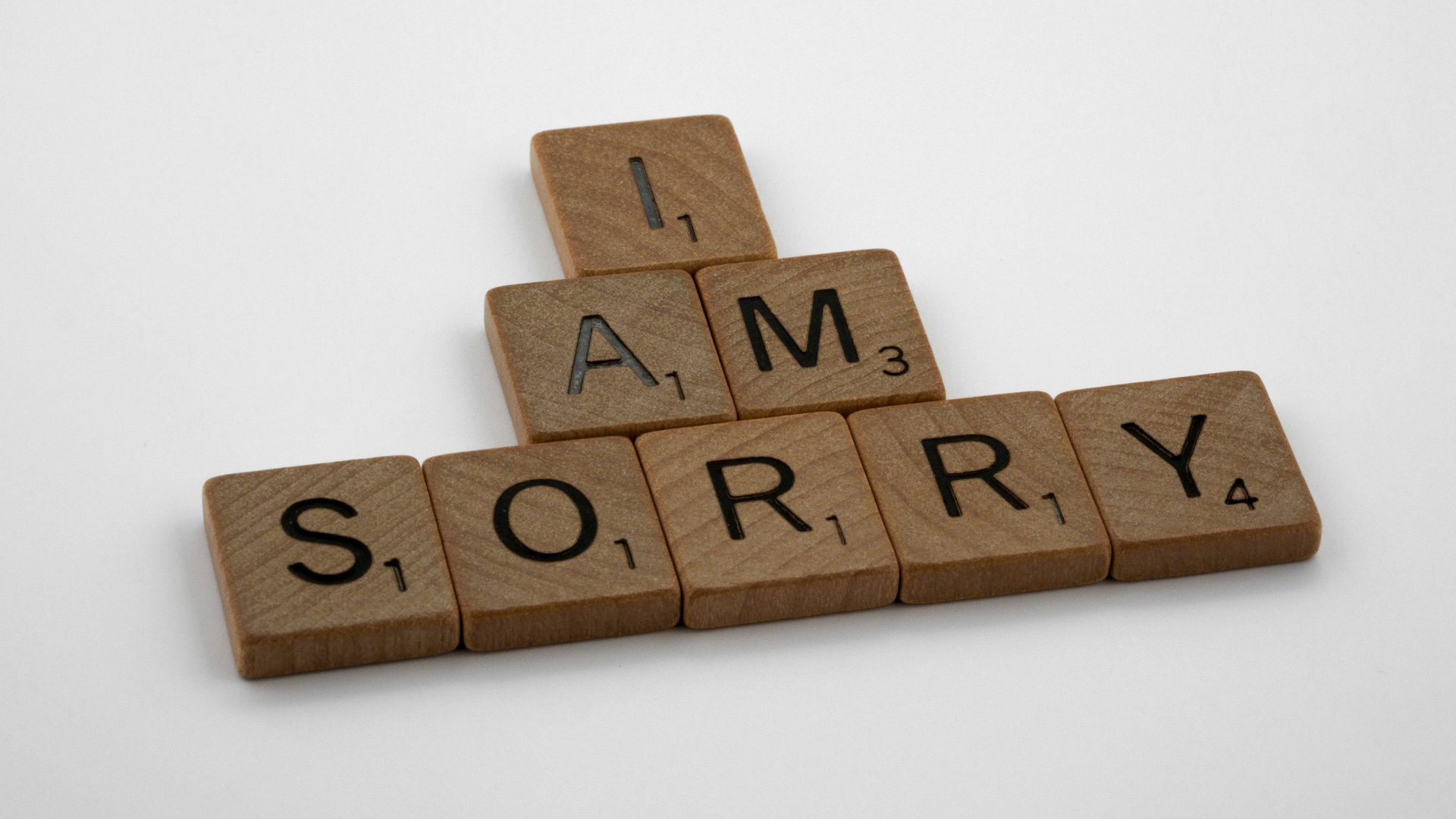 brown wooden letter blocks on white surface