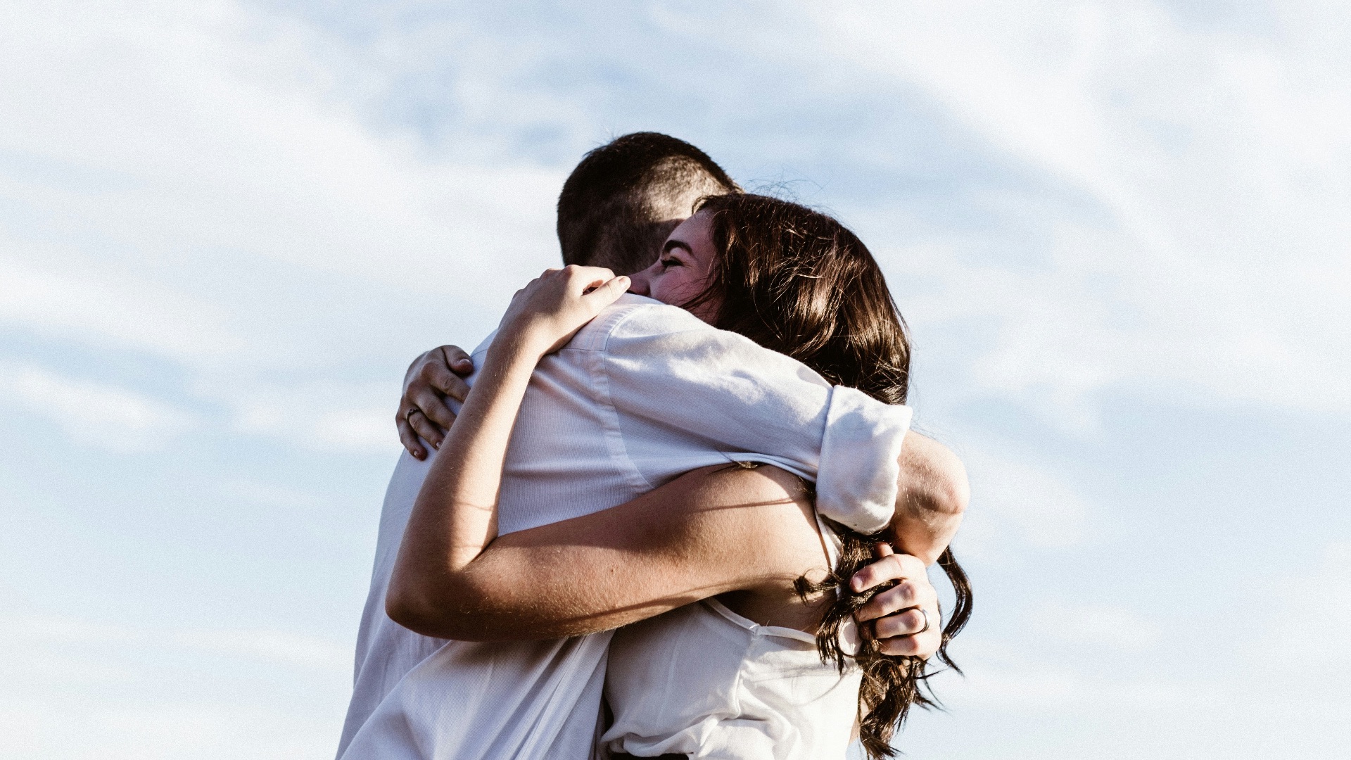 man and woman hugging each other photography