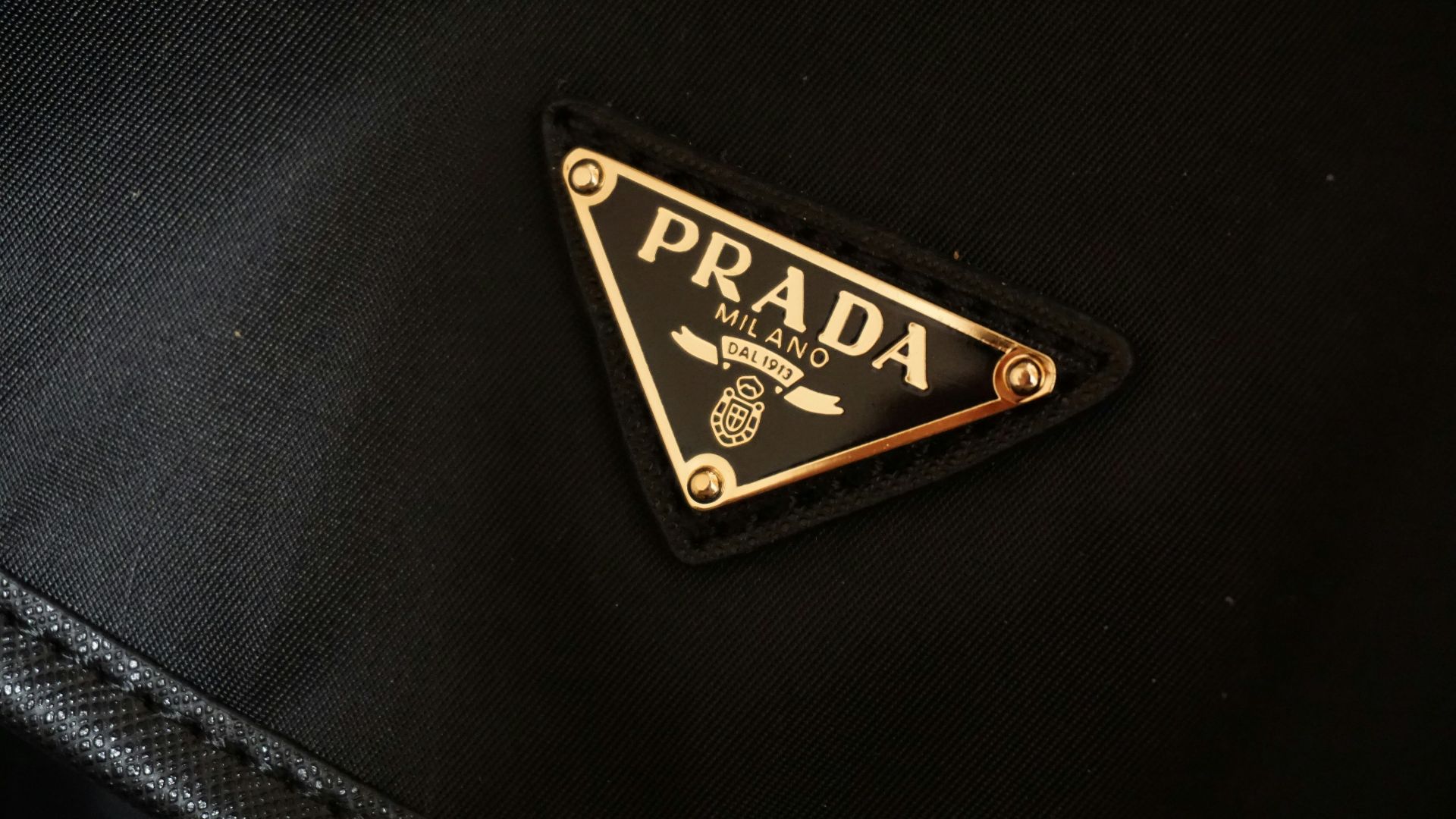 a prada logo on a black jacket