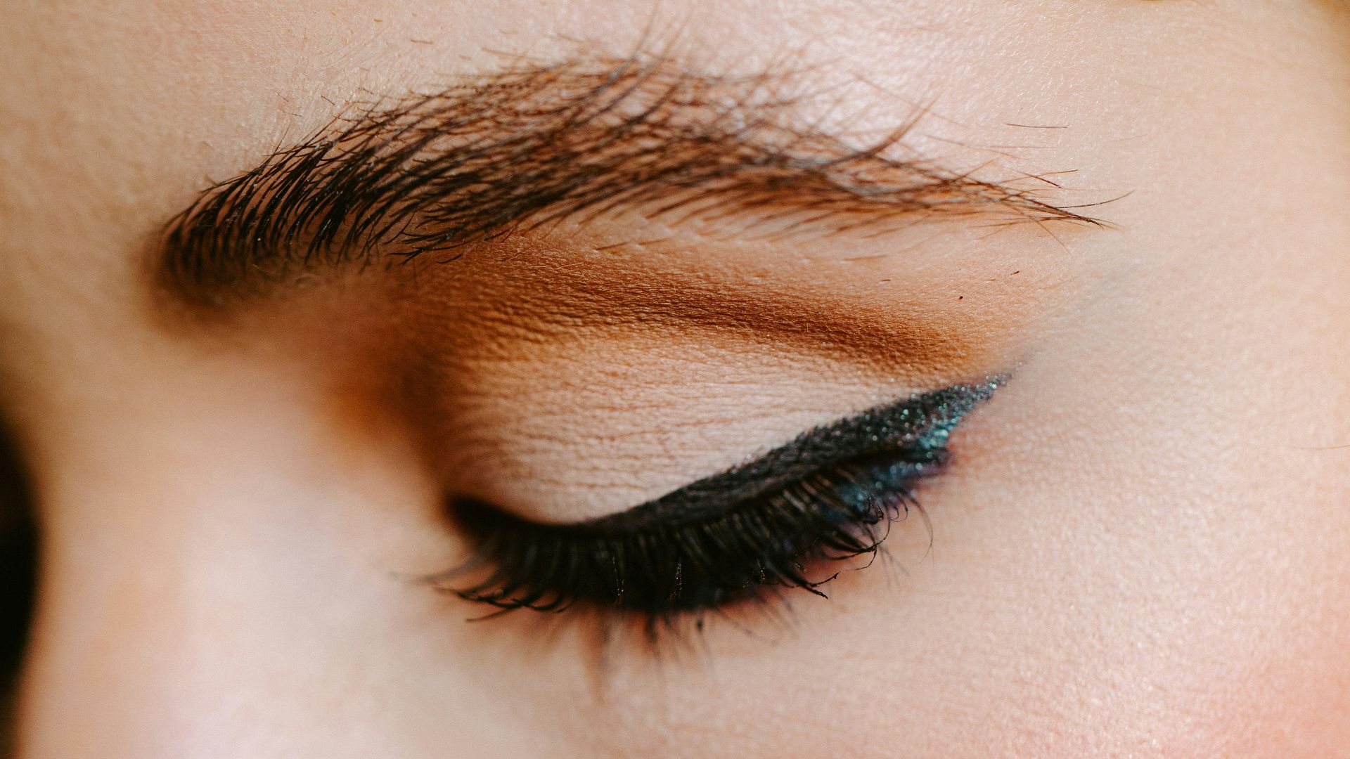 woman with red lipstick and black mascara