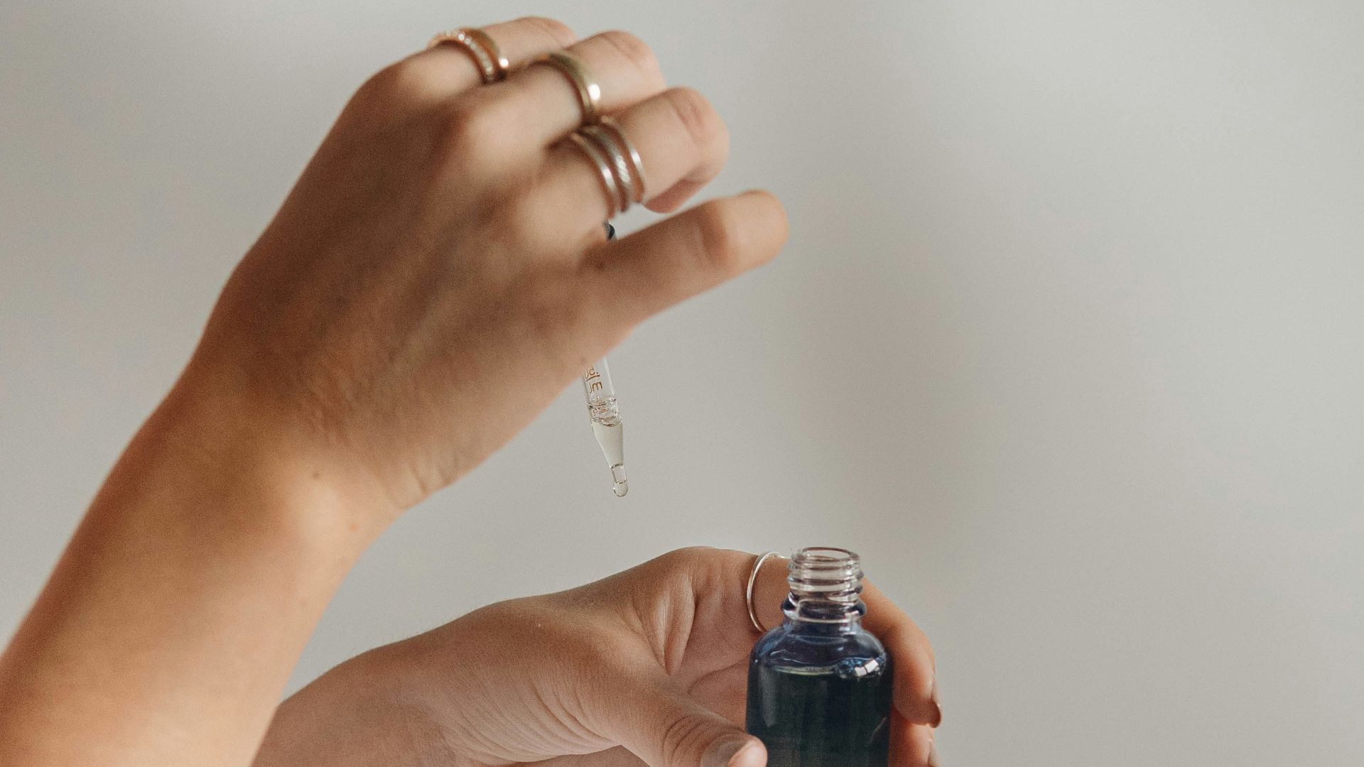 person holding black glass bottle