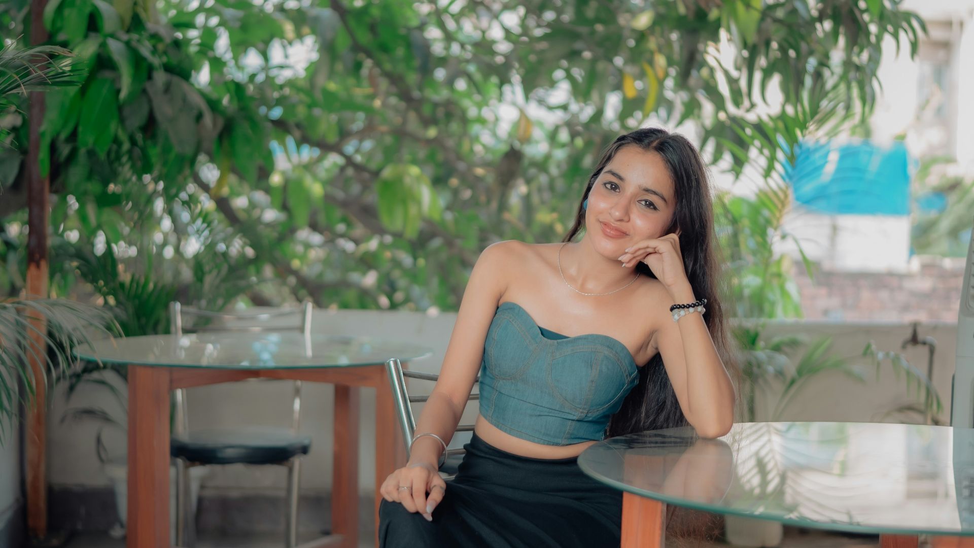 Young woman sitting at a table outdoors