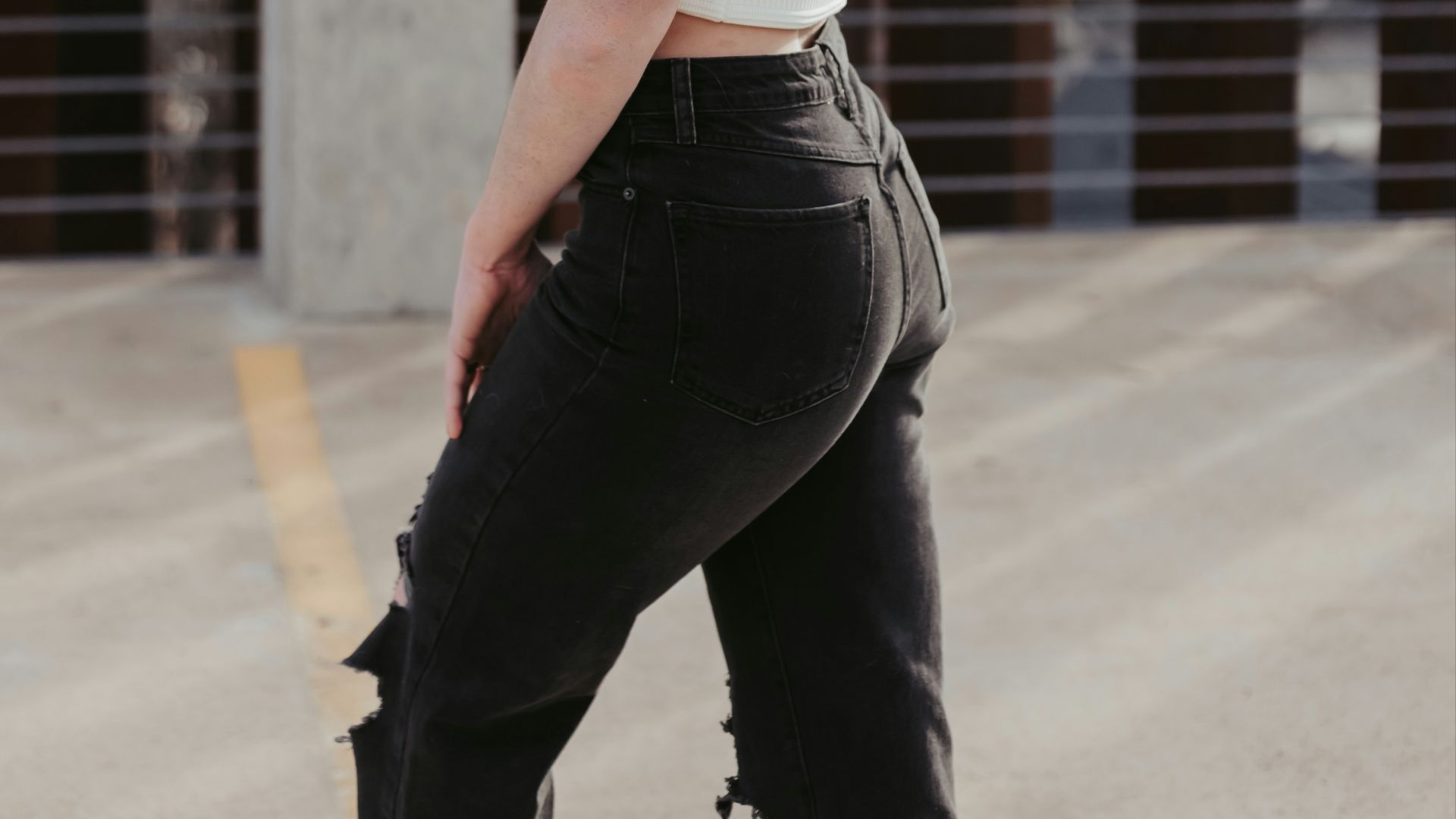 a woman in black pants and a white top