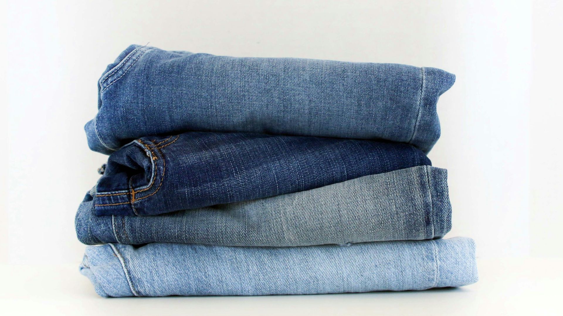 a stack of jeans sitting on top of each other