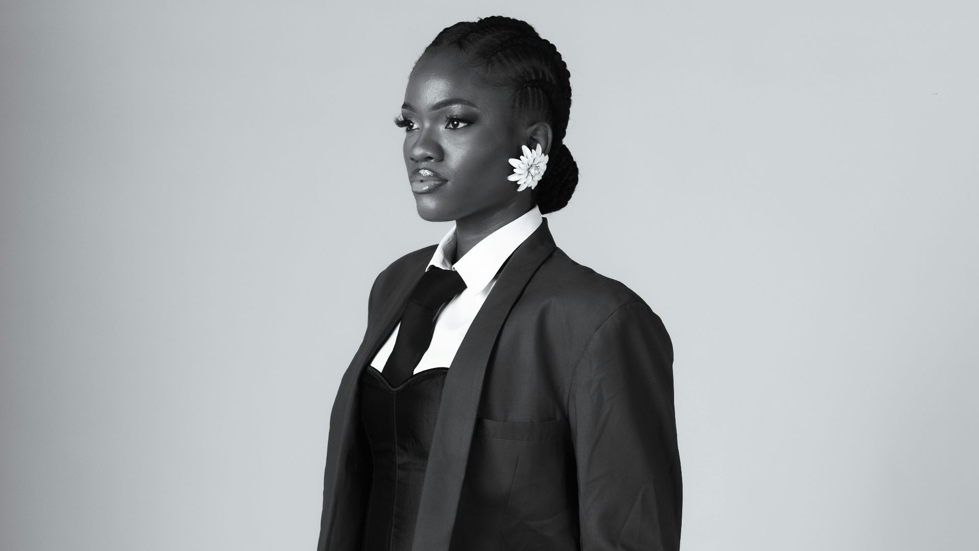 Woman in a suit with hands in pockets