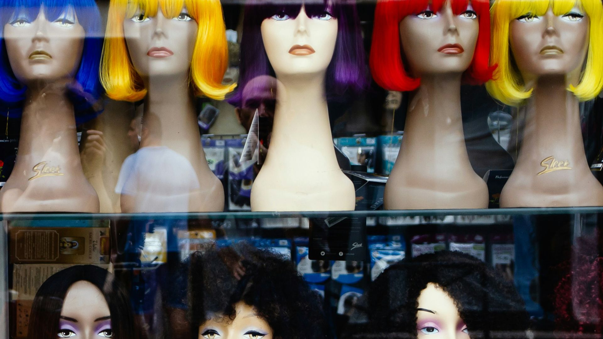 a bunch of wigs that are on display