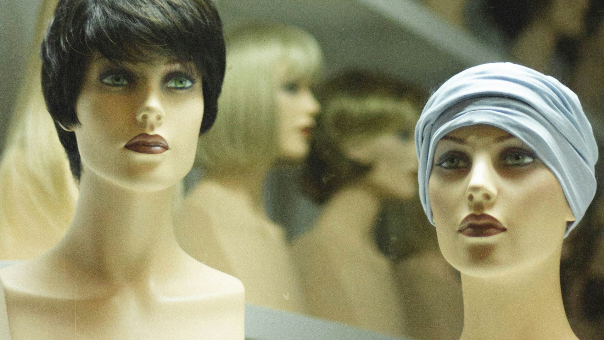 woman in white hijab beside woman in black shirt