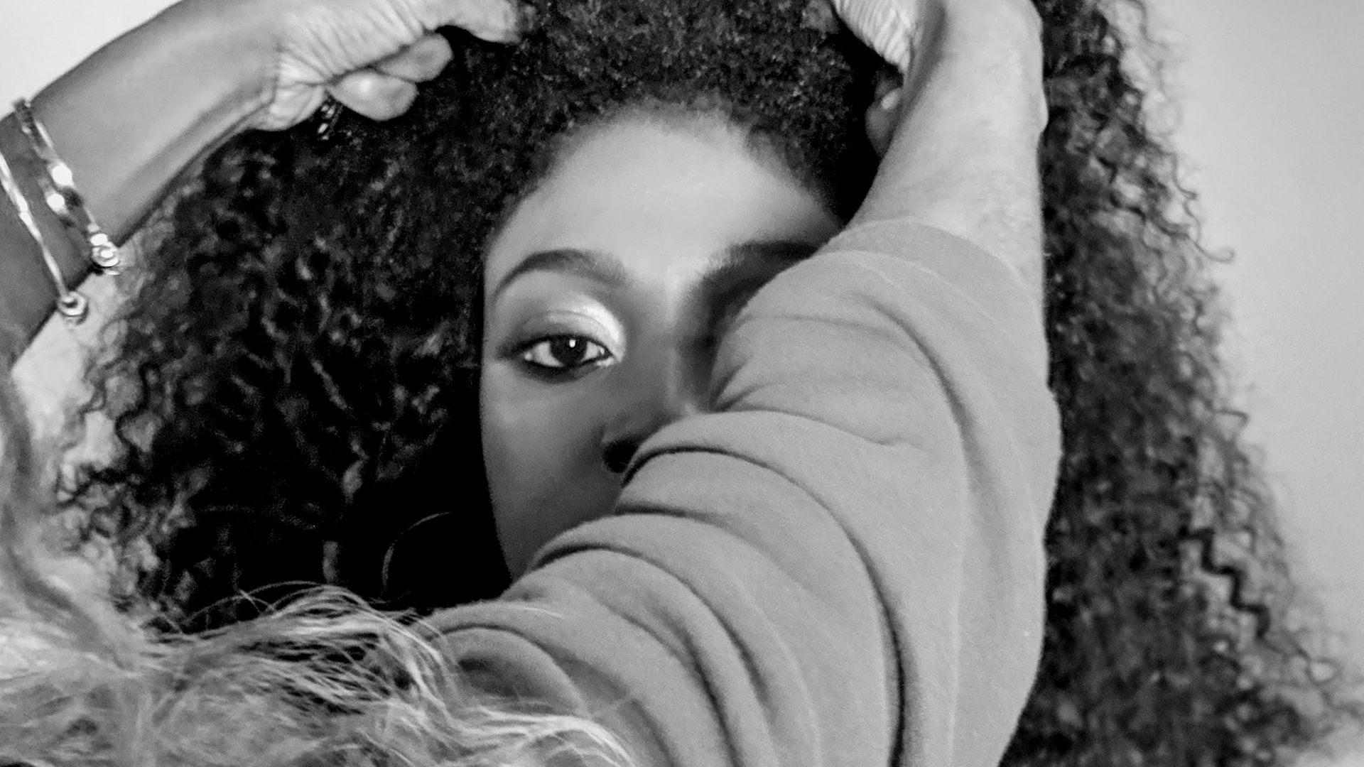 grayscale photo of woman in long sleeve shirt