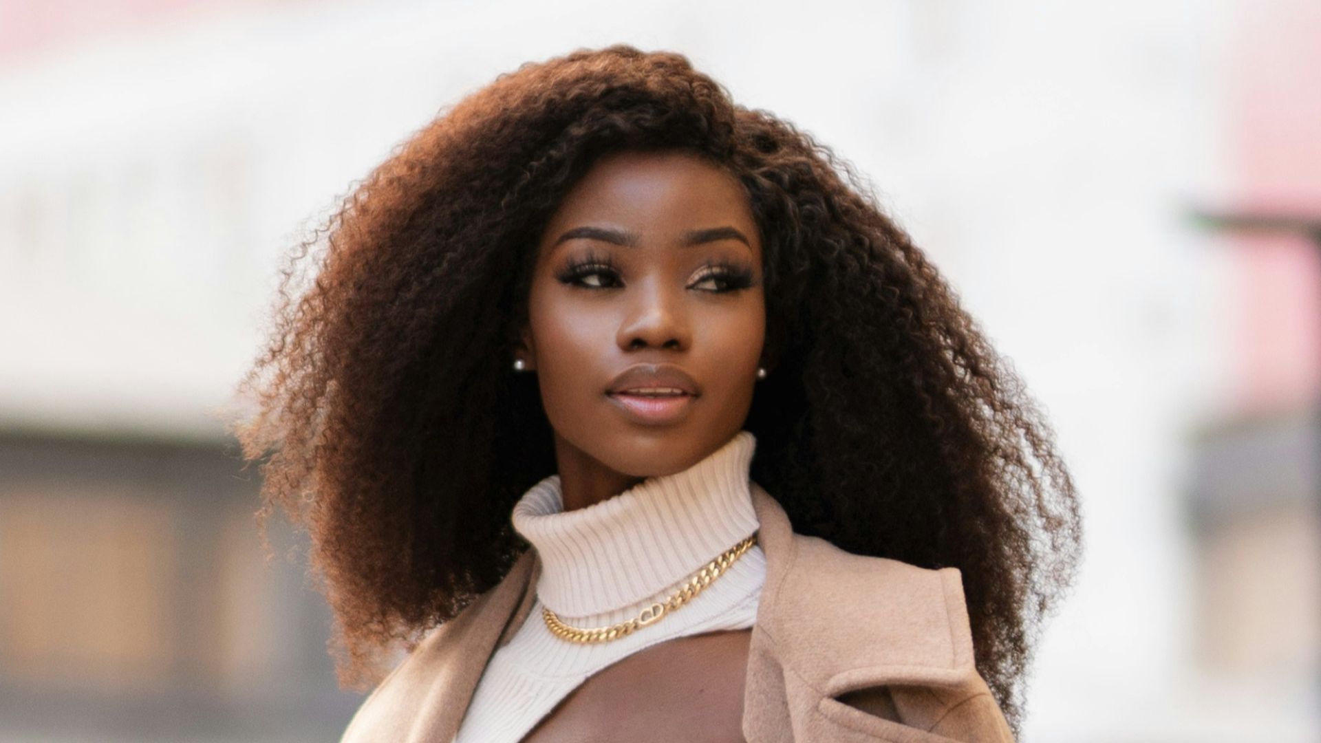 woman in white long sleeve shirt and white pants standing on road during daytime
