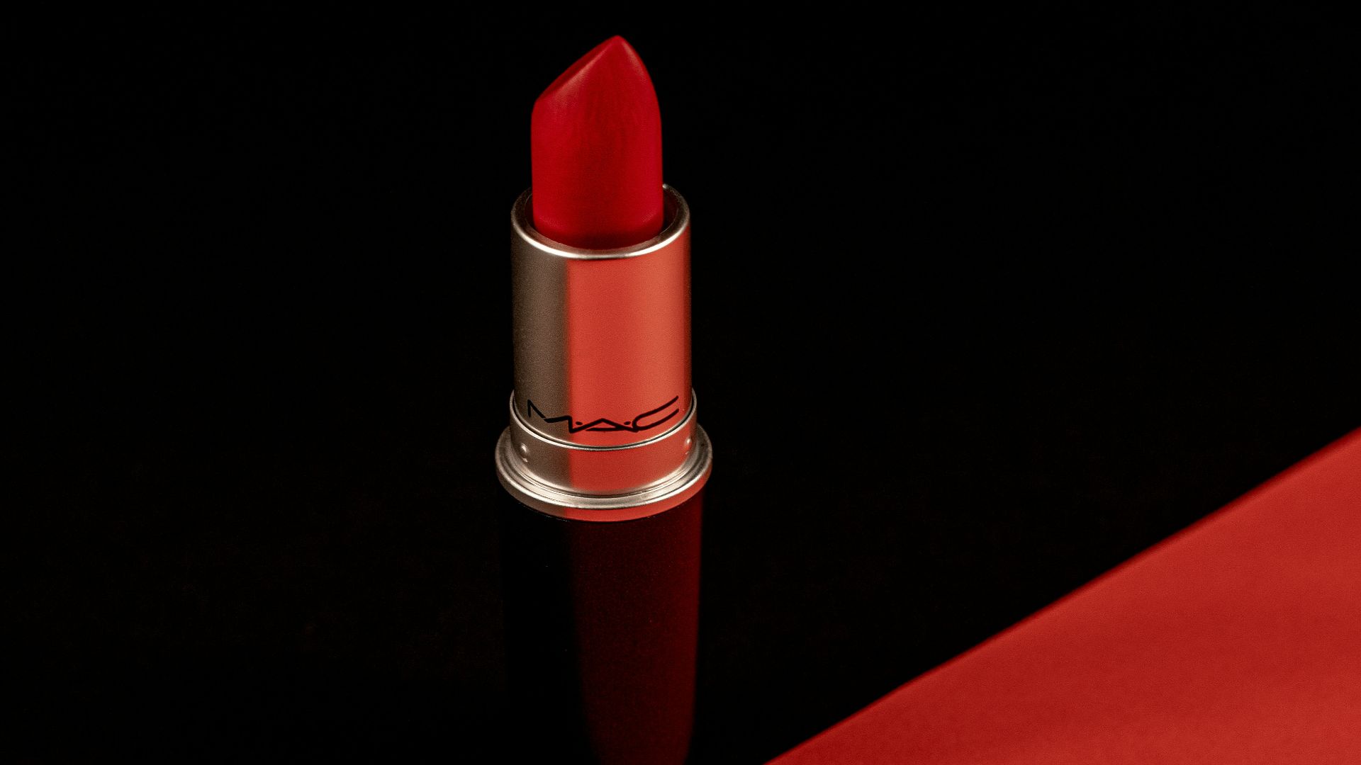 a red lipstick with a black background