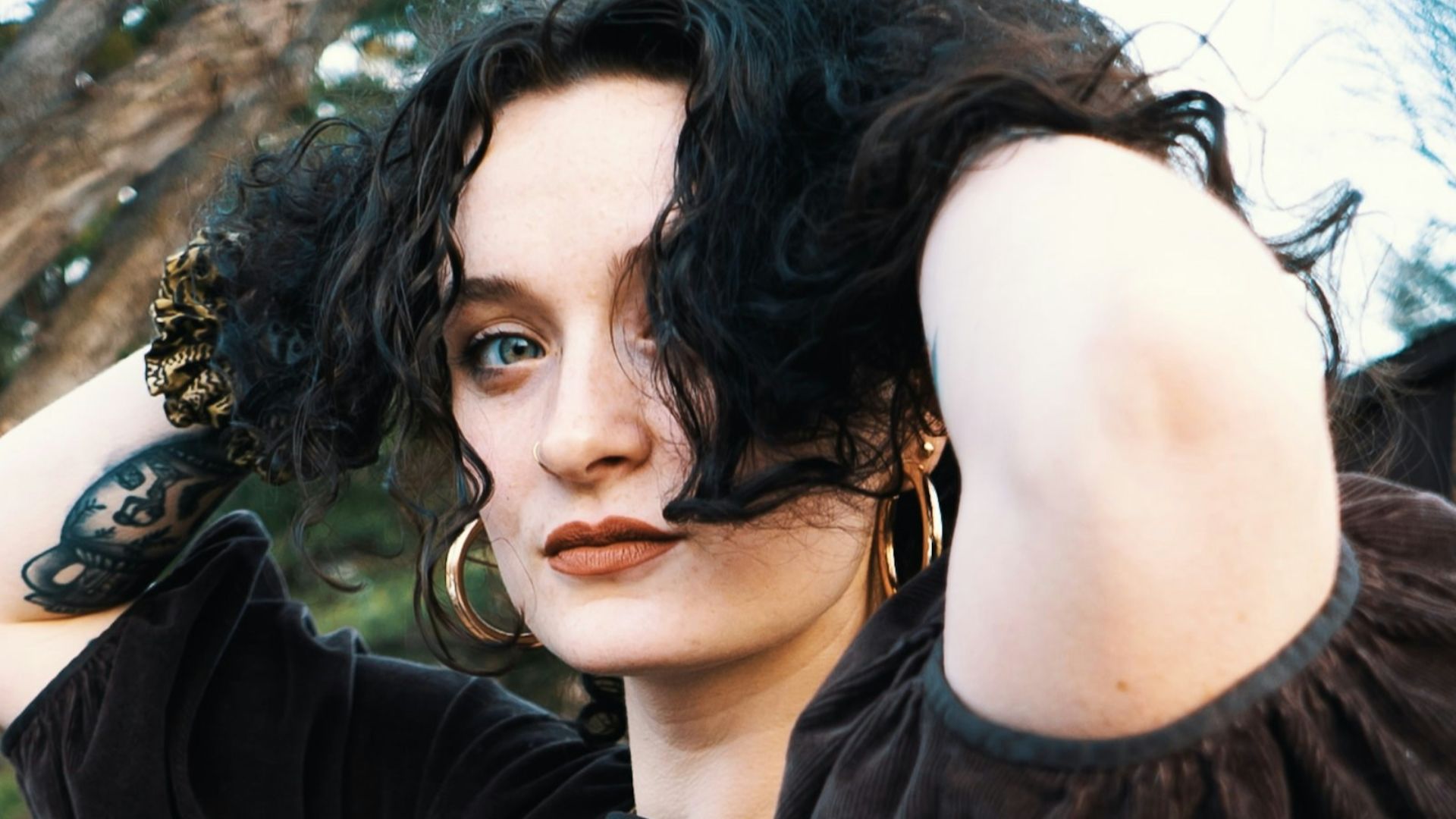 a woman in a black dress posing for a picture