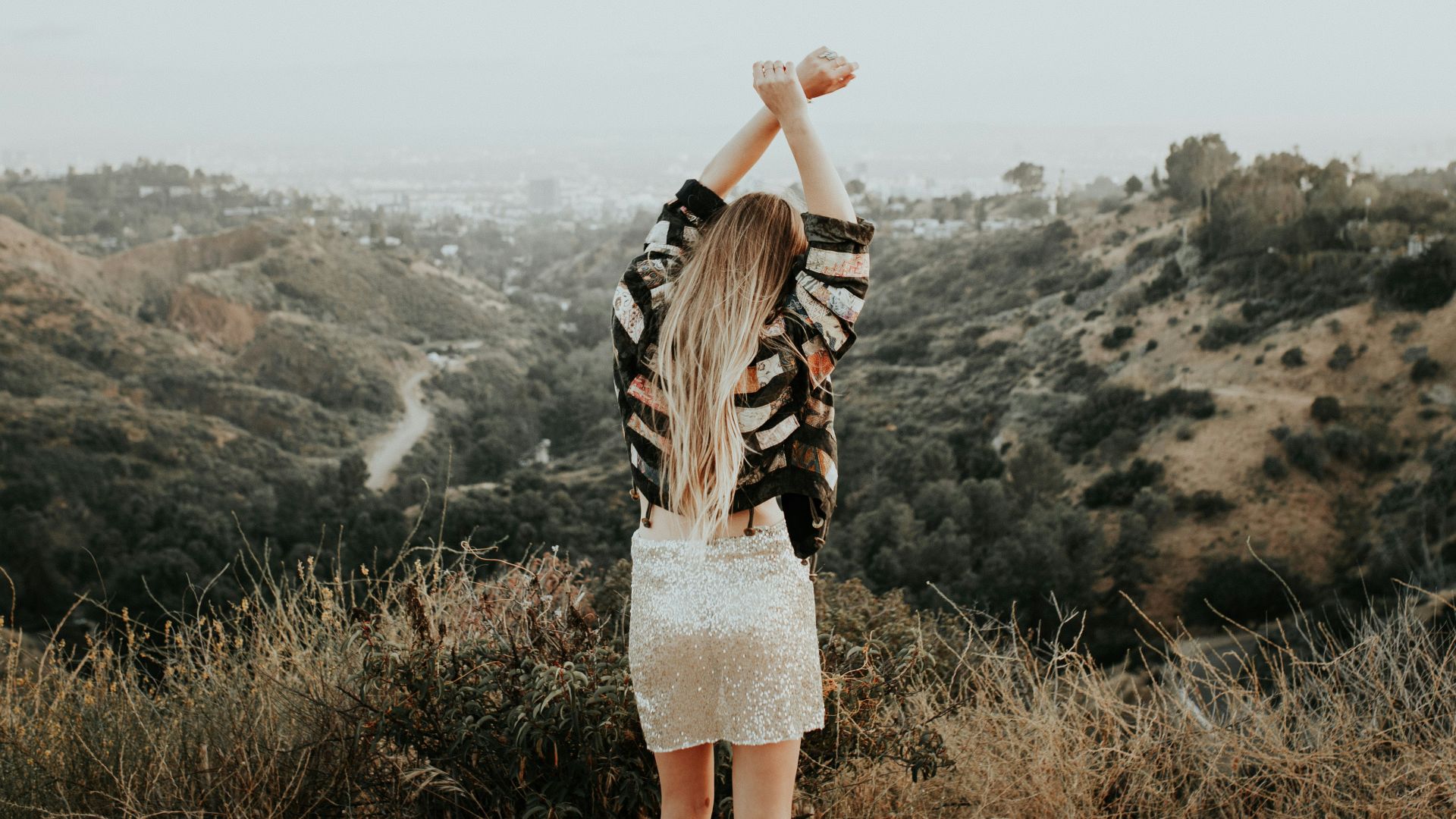 woman standing on top of mountain