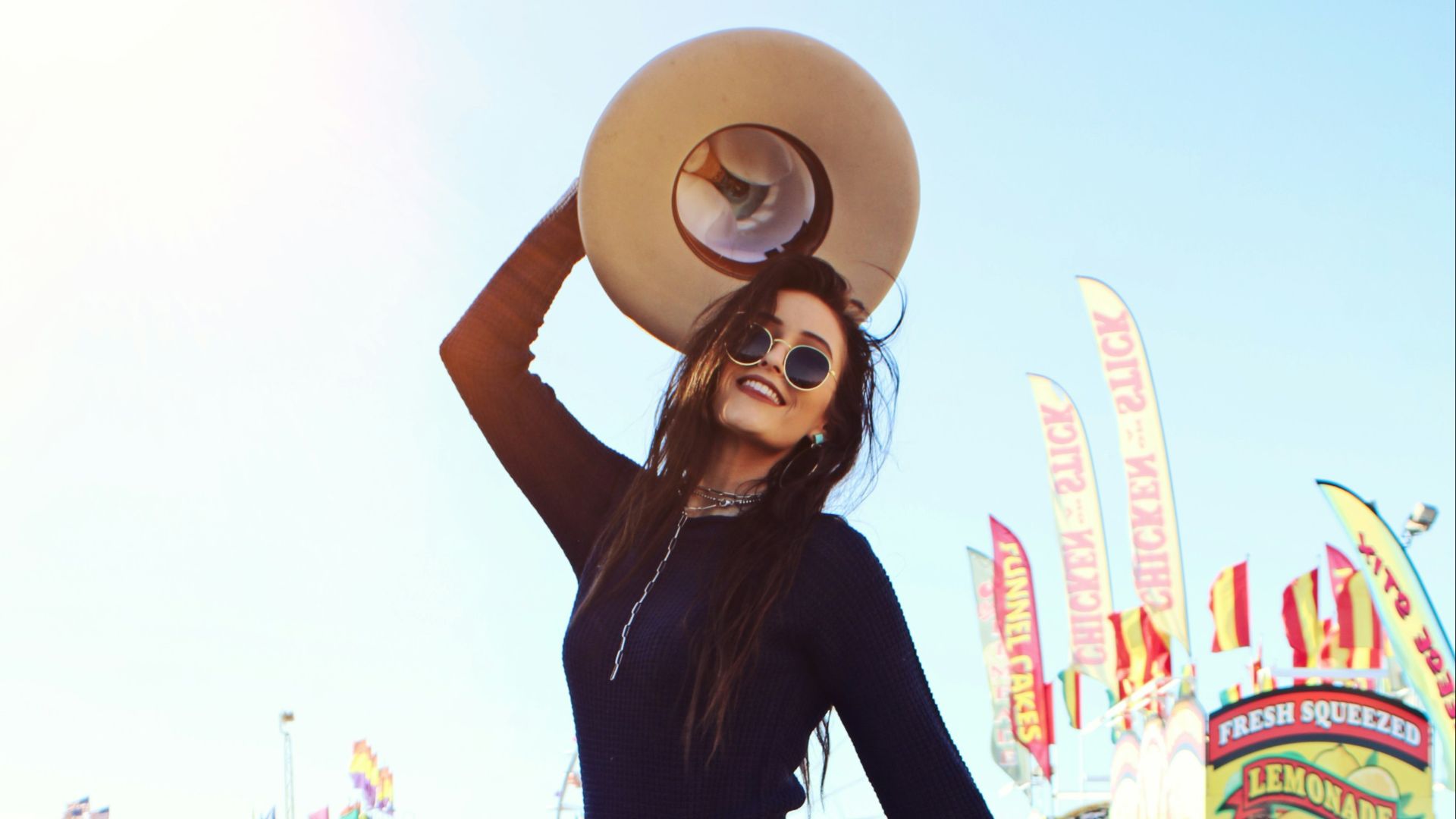 a woman in a plaid skirt and cowboy hat