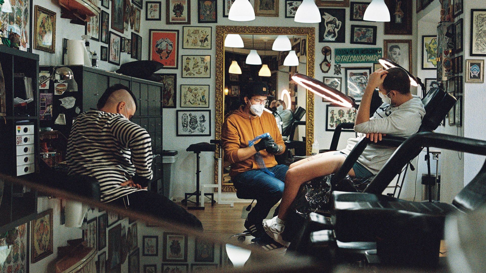 man in orange polo shirt sitting on black leather armchair