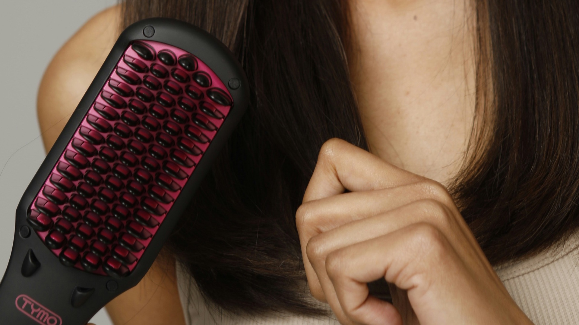 a woman holding a hair brush in her hand