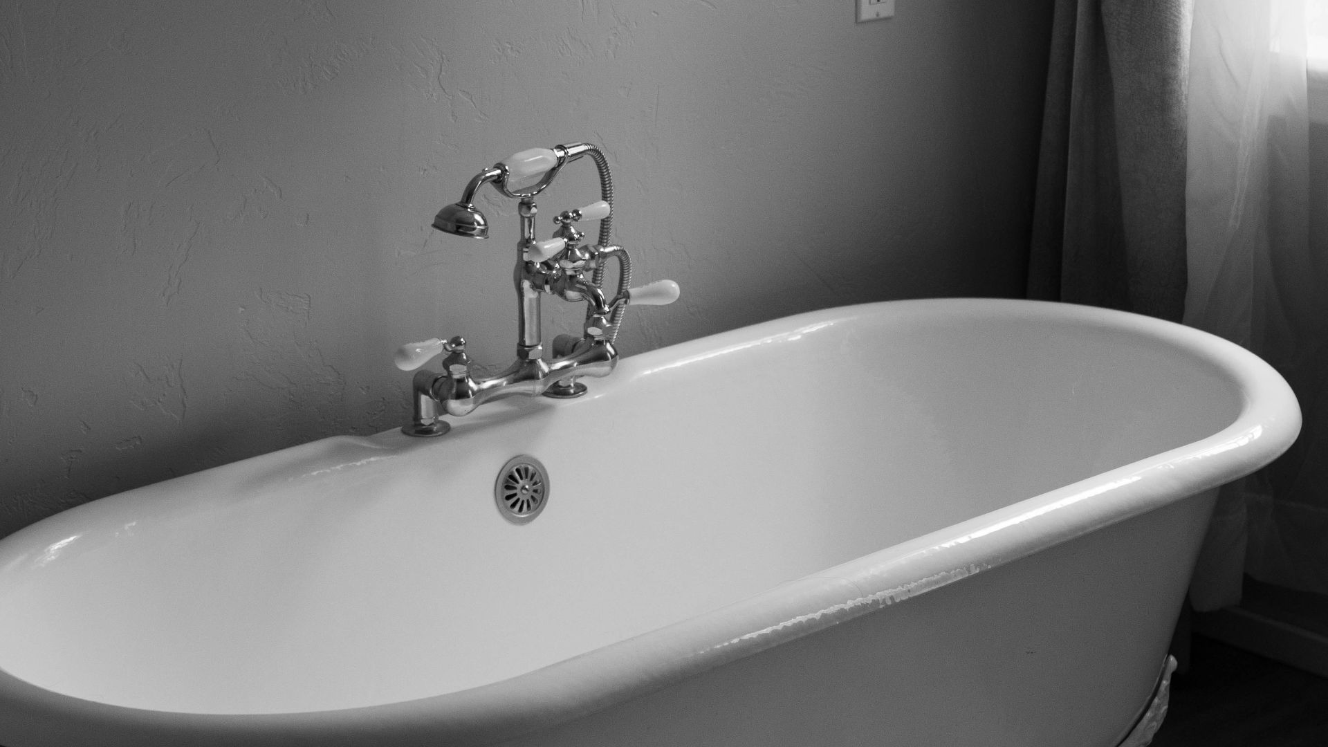white ceramic bath tub inside room