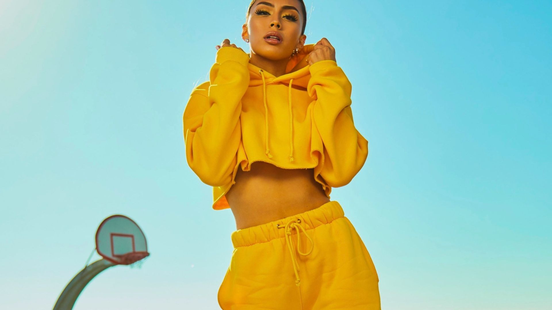 woman in yellow tracksuit standing on basketball court side