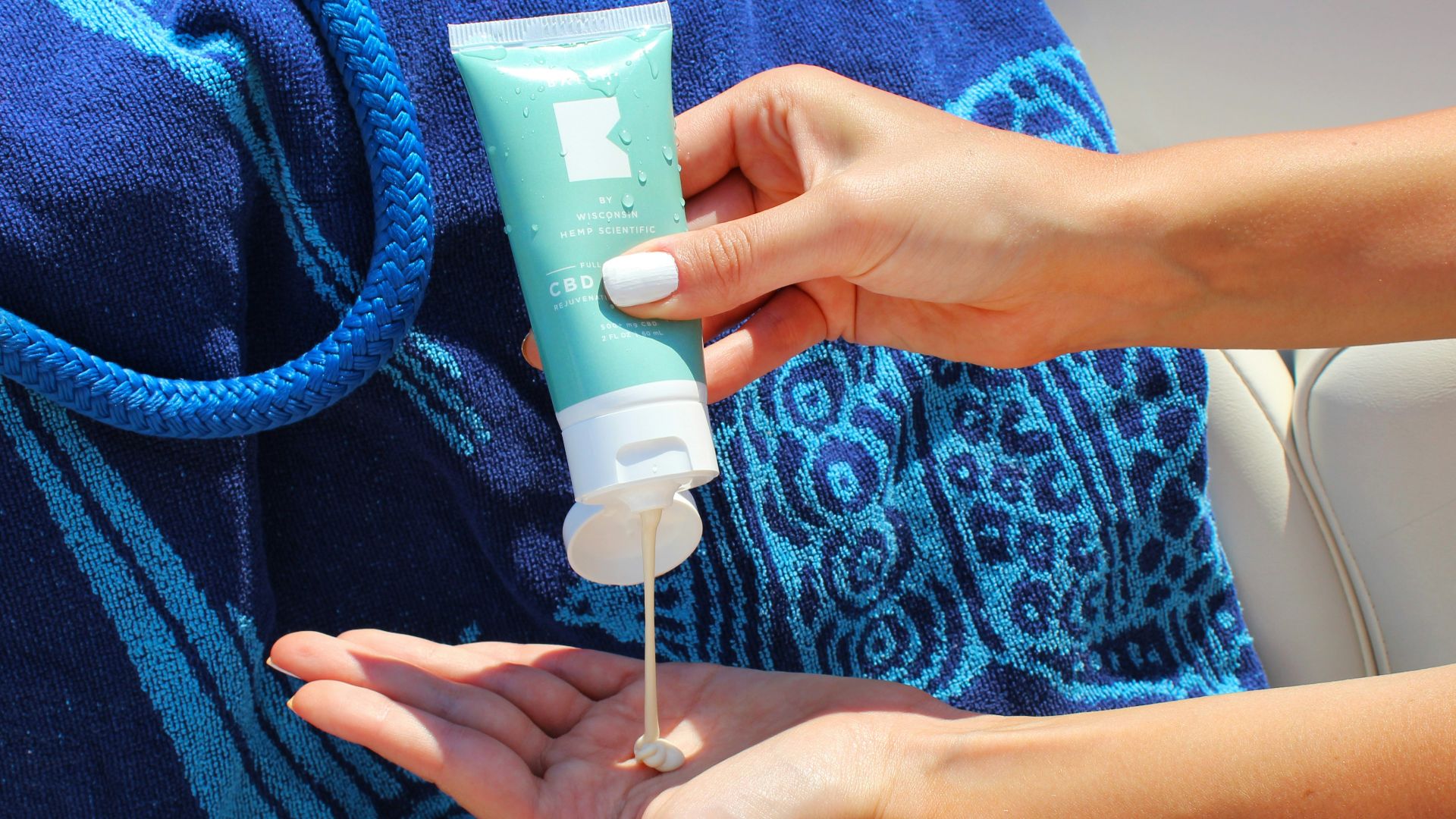 person holding white plastic tube bottle