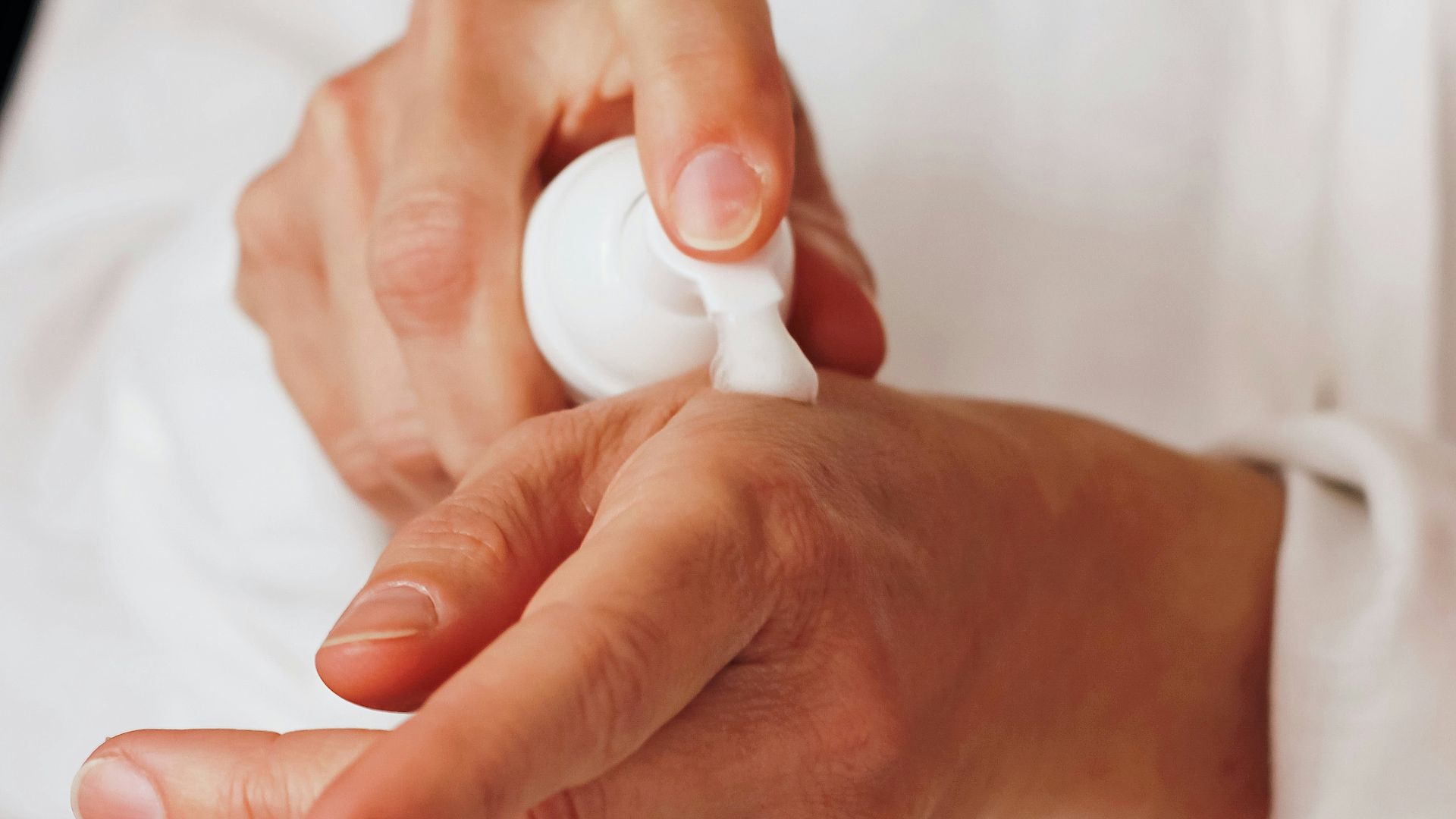 person holding white round ornament