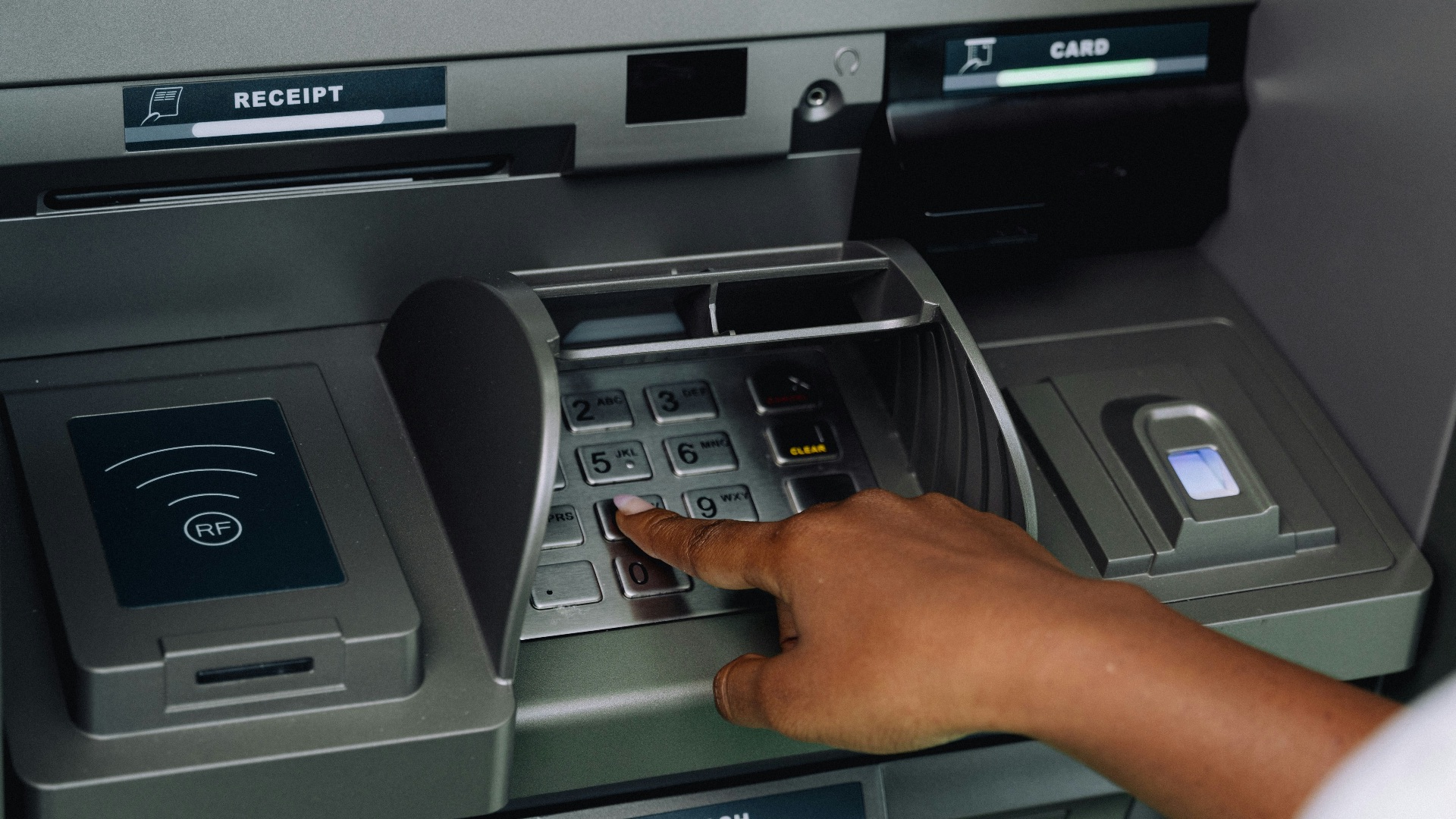 a person using an atm machine to pay money