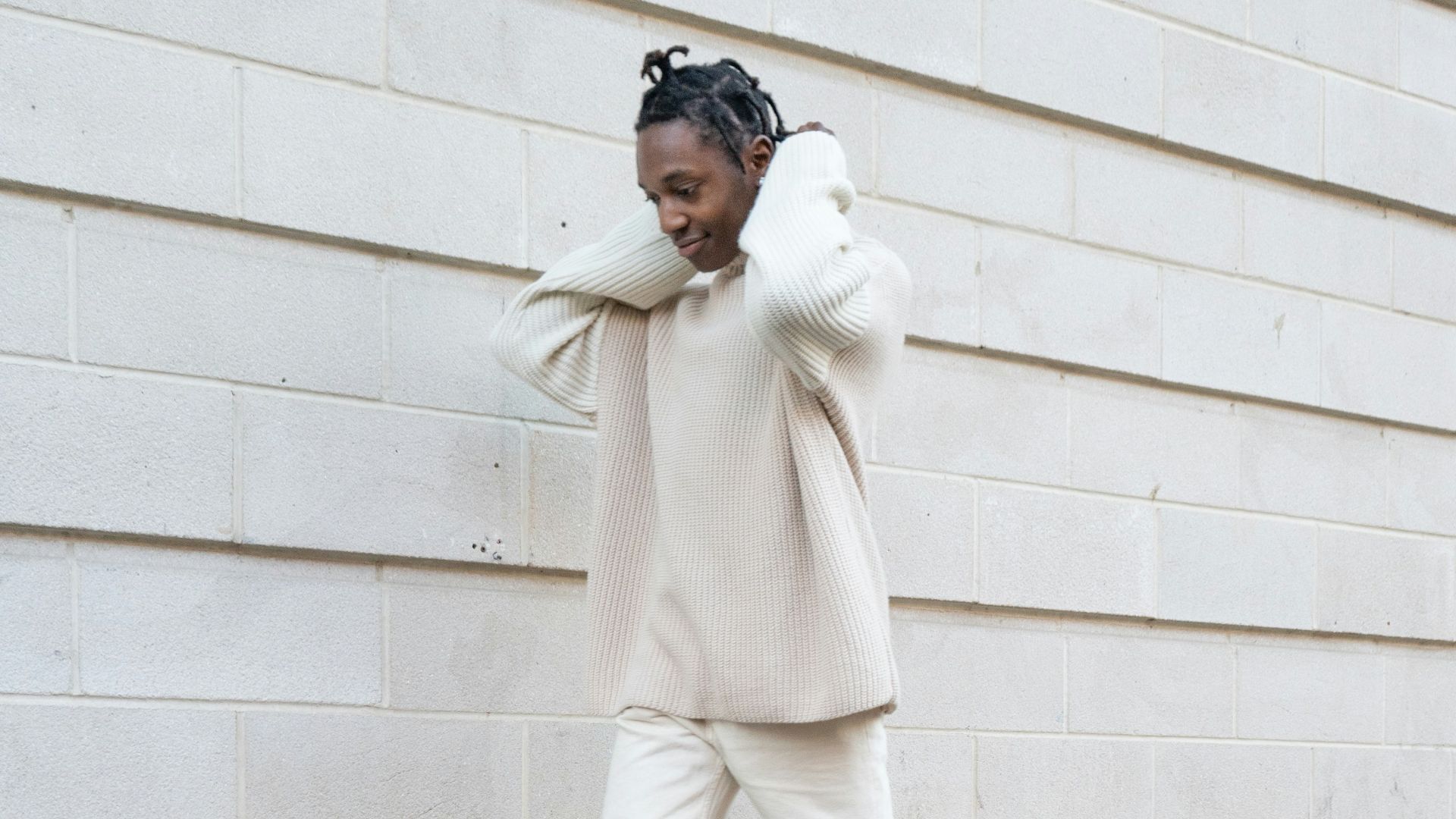 a woman walking down a sidewalk while talking on a cell phone