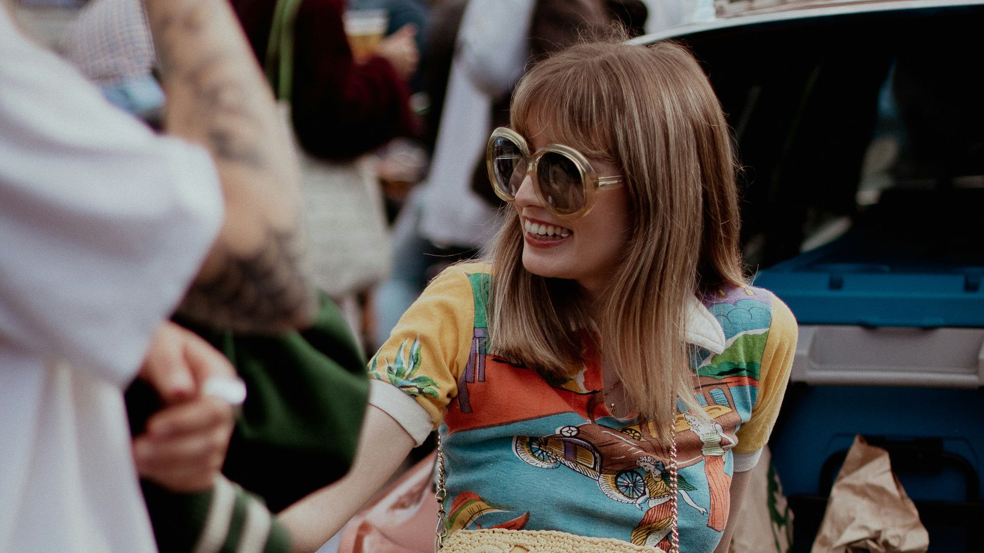 a woman sitting on the back of a car