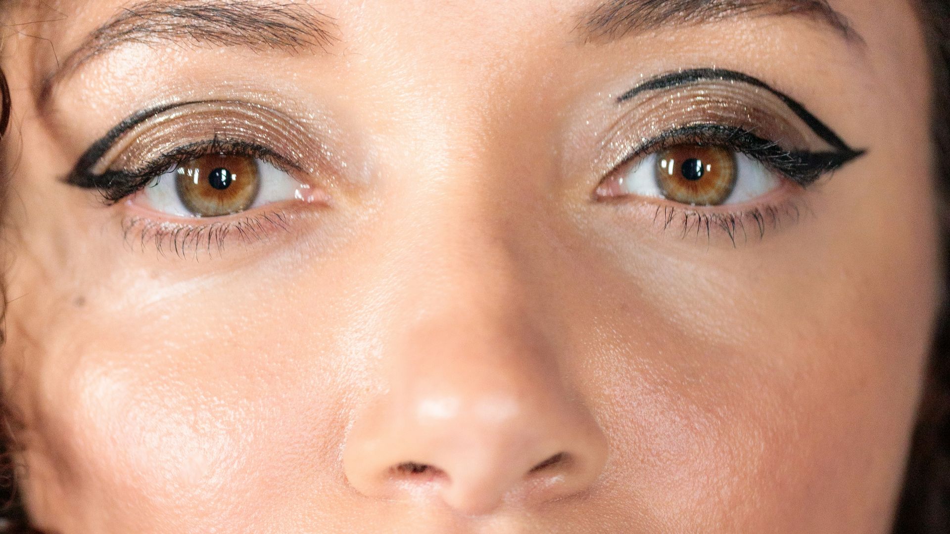 woman with red lipstick and black mascara