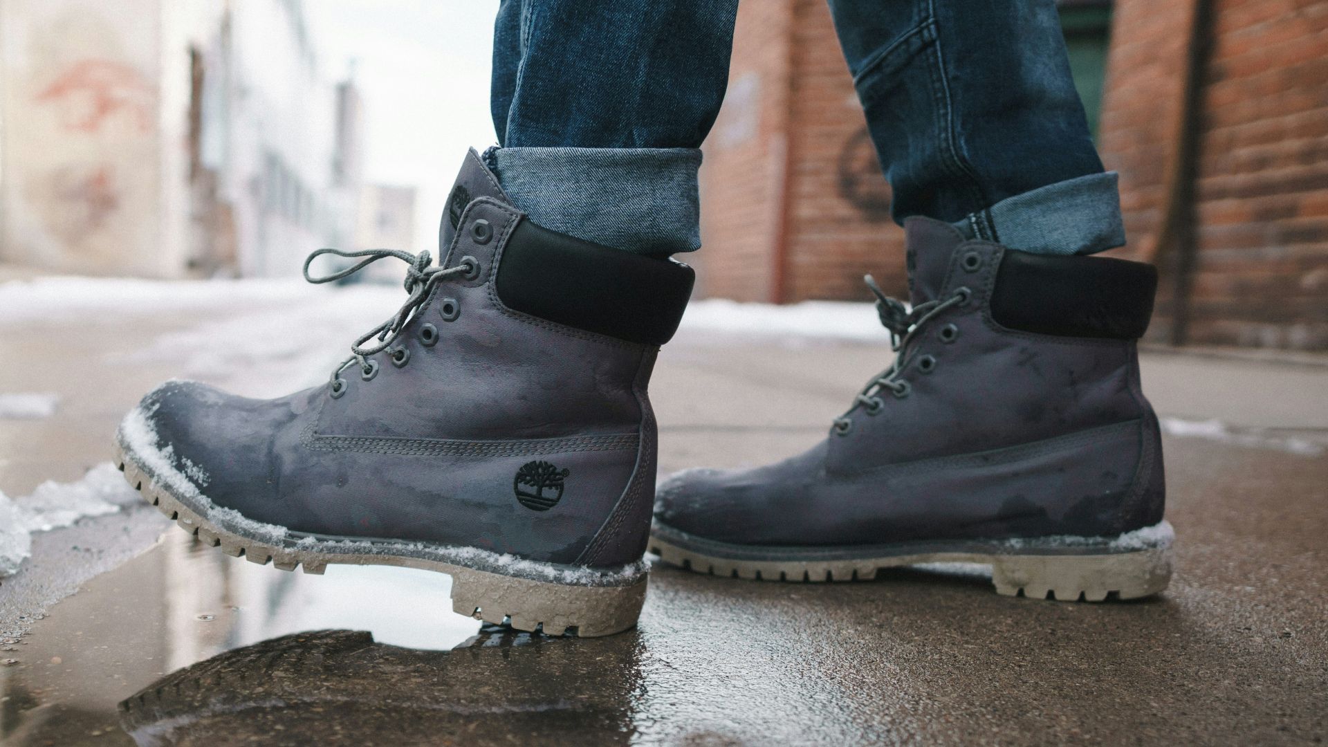 person wearing pair of gray Timberland work boots