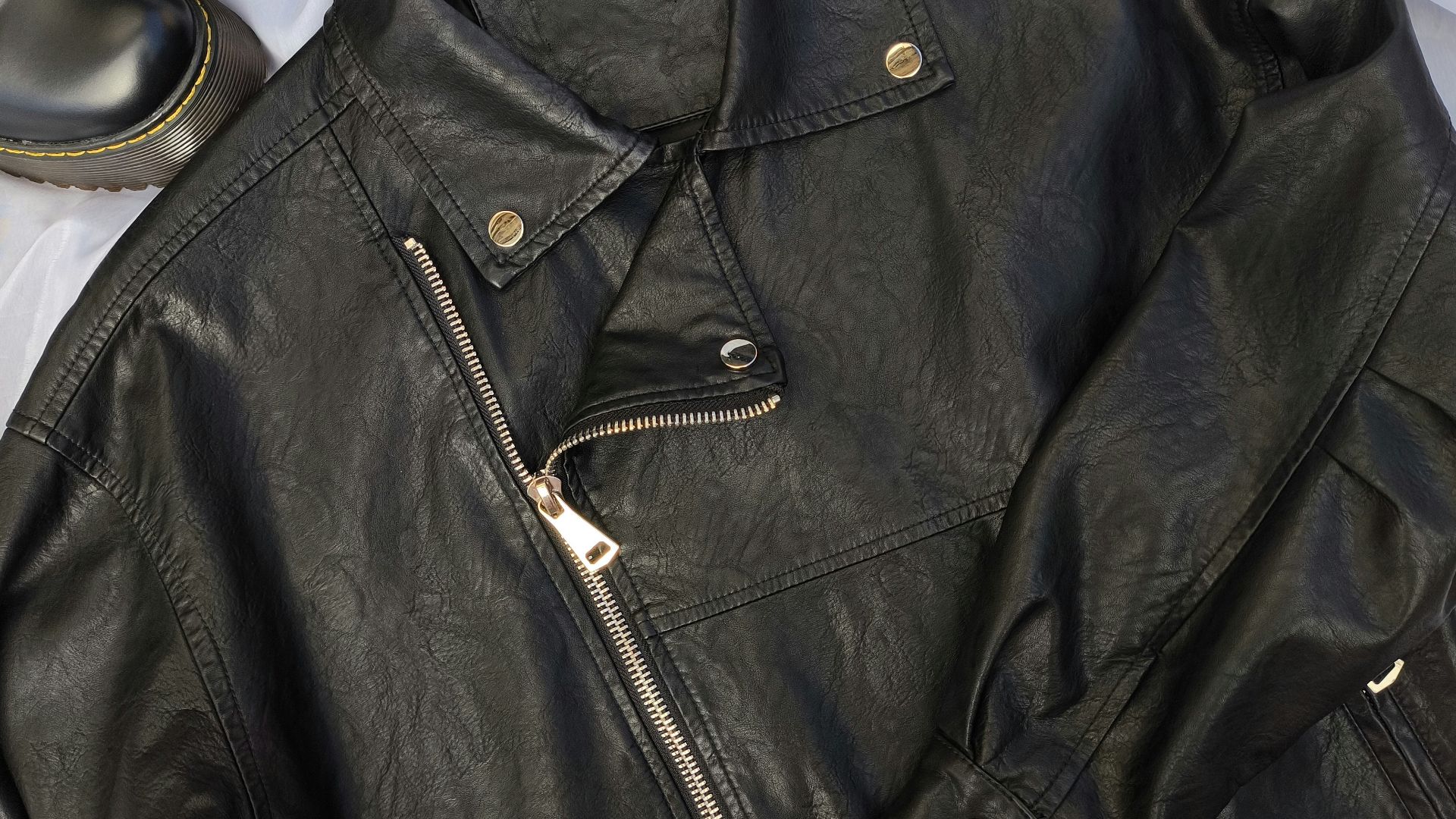 A pair of black shoes and a black leather jacket