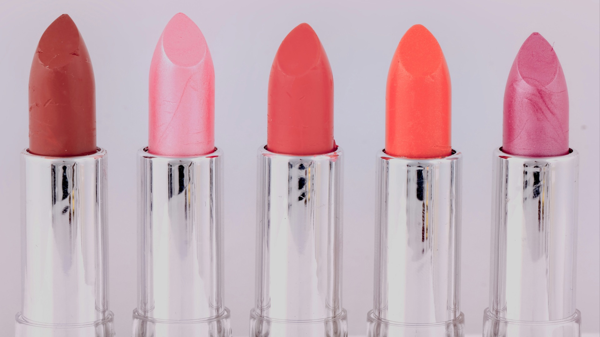 five assorted-color lipsticks