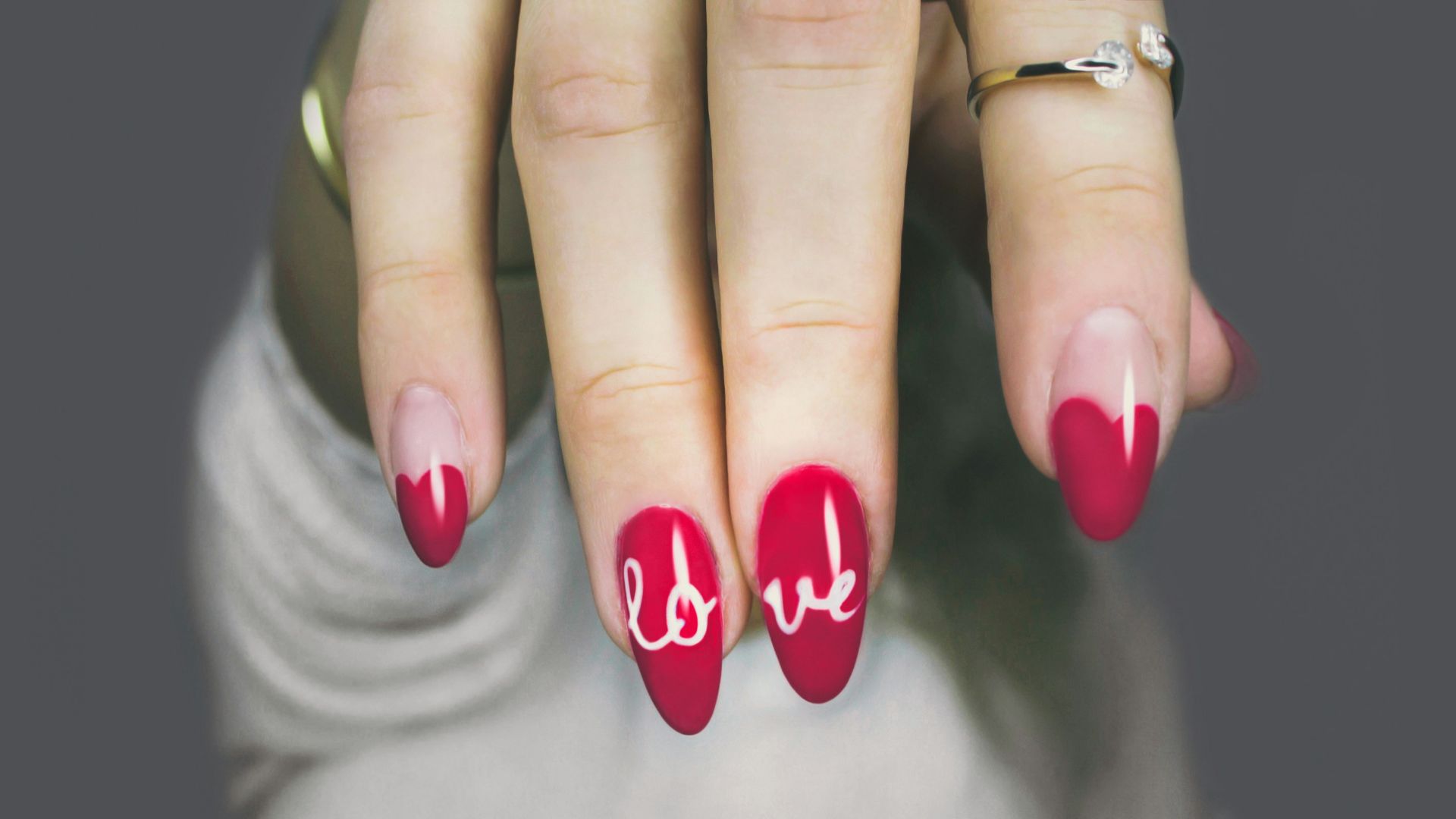 selective focus photography of woman's pink manicure