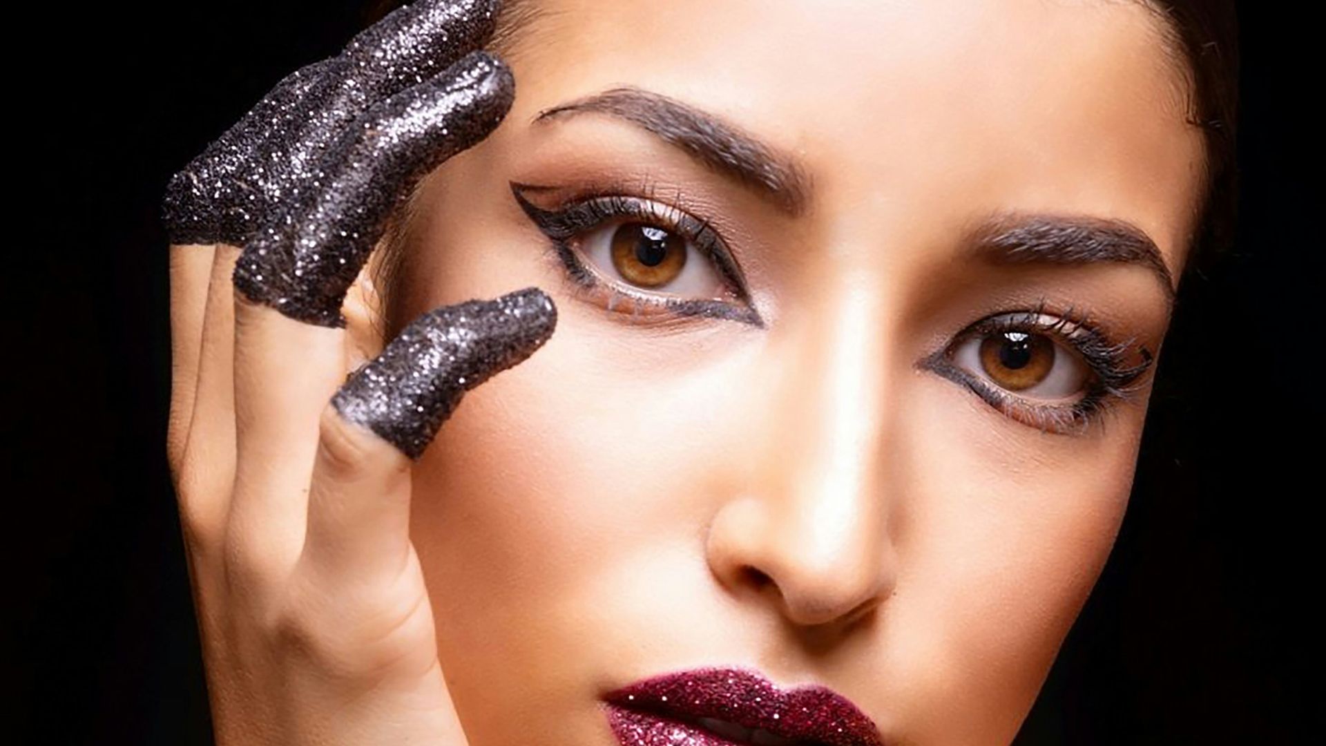 Woman with glittery makeup and nails