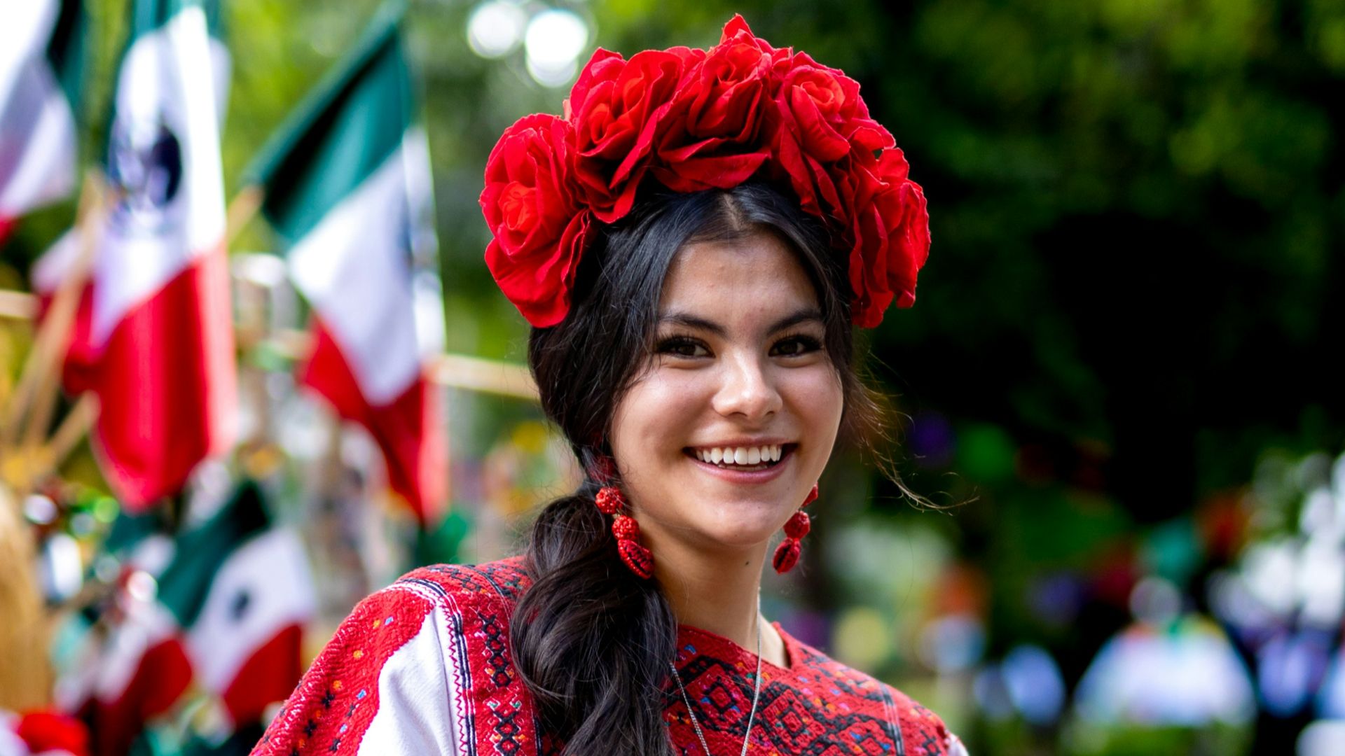 a woman wearing a red skirt and a red flower in her hair