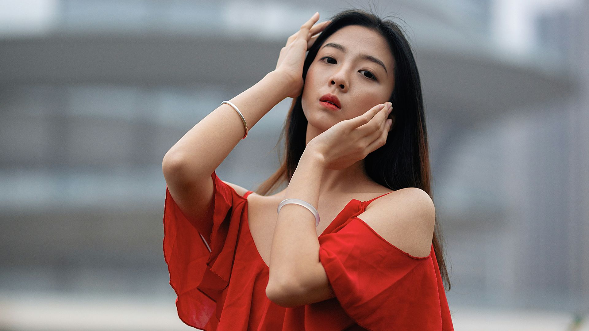 woman in orange dress standing on green grass field during daytime
