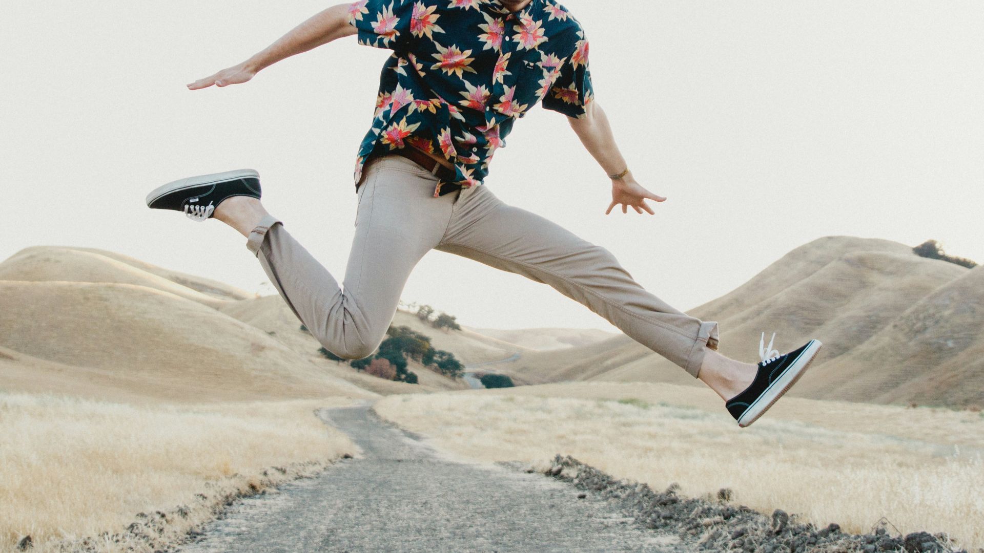 man in black shirt and gray pants jumping