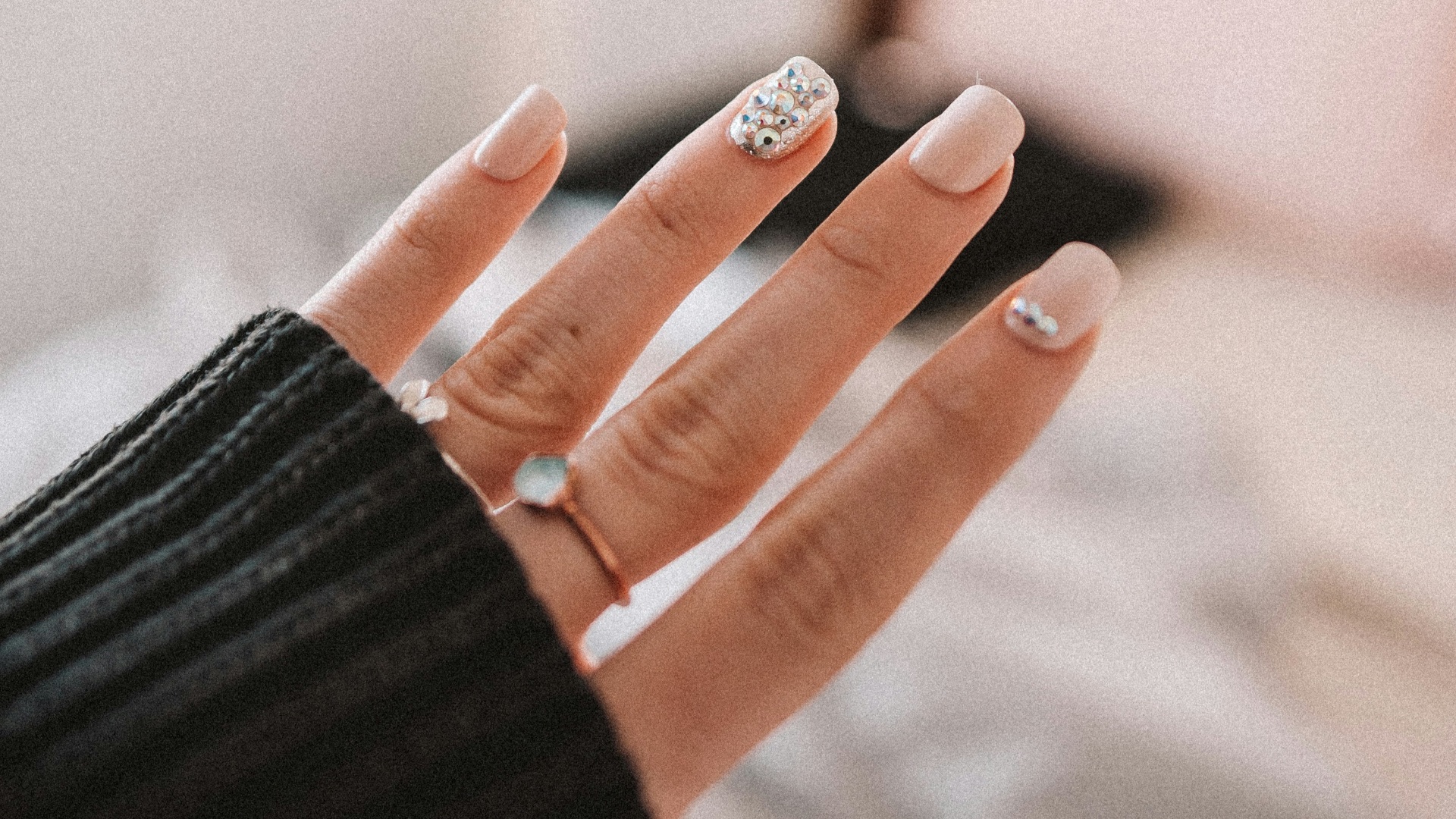 person wearing silver ring and black long sleeve shirt