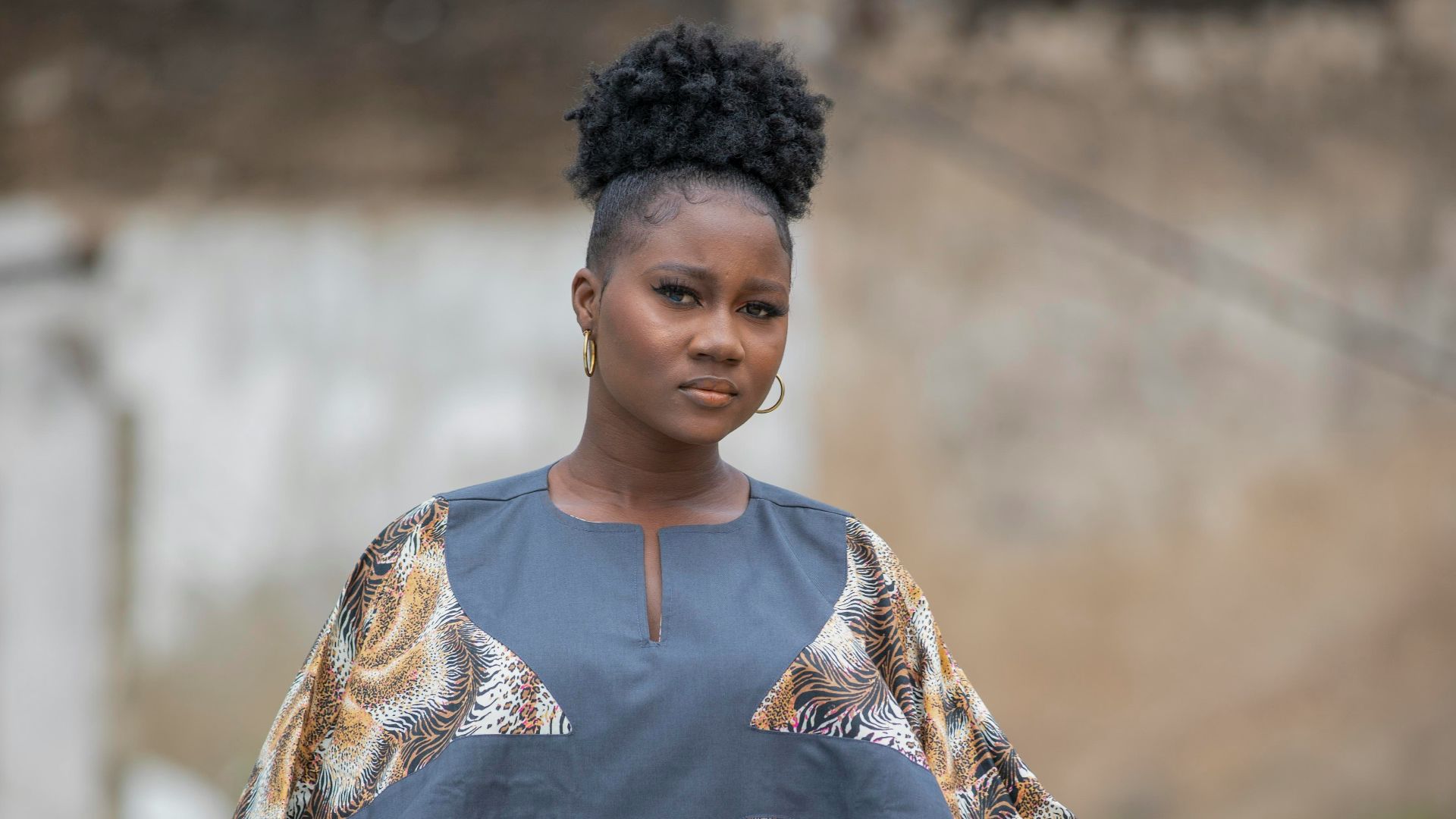 a person wearing a large gold and black dress