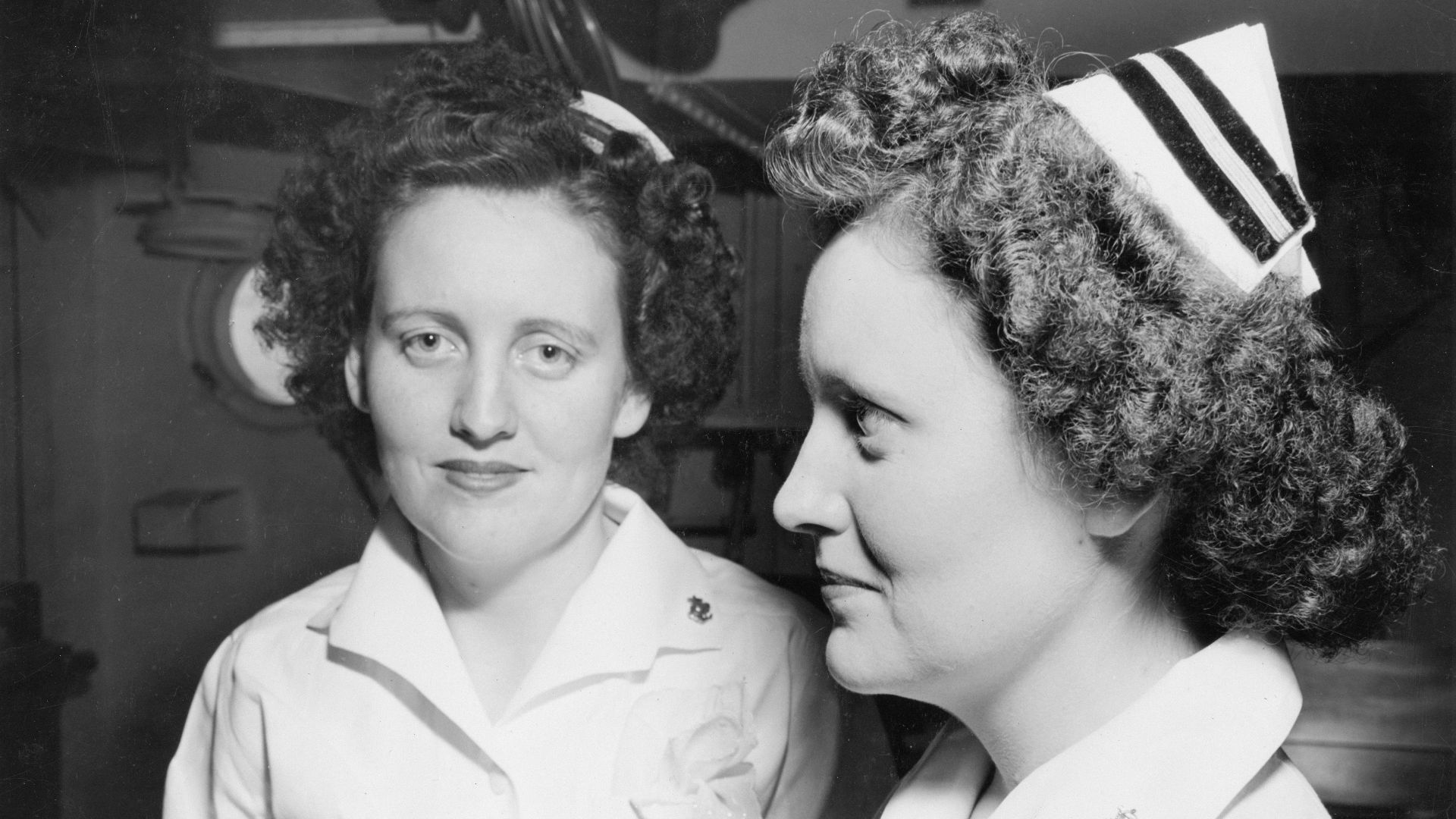 Two nurses in uniform stand together