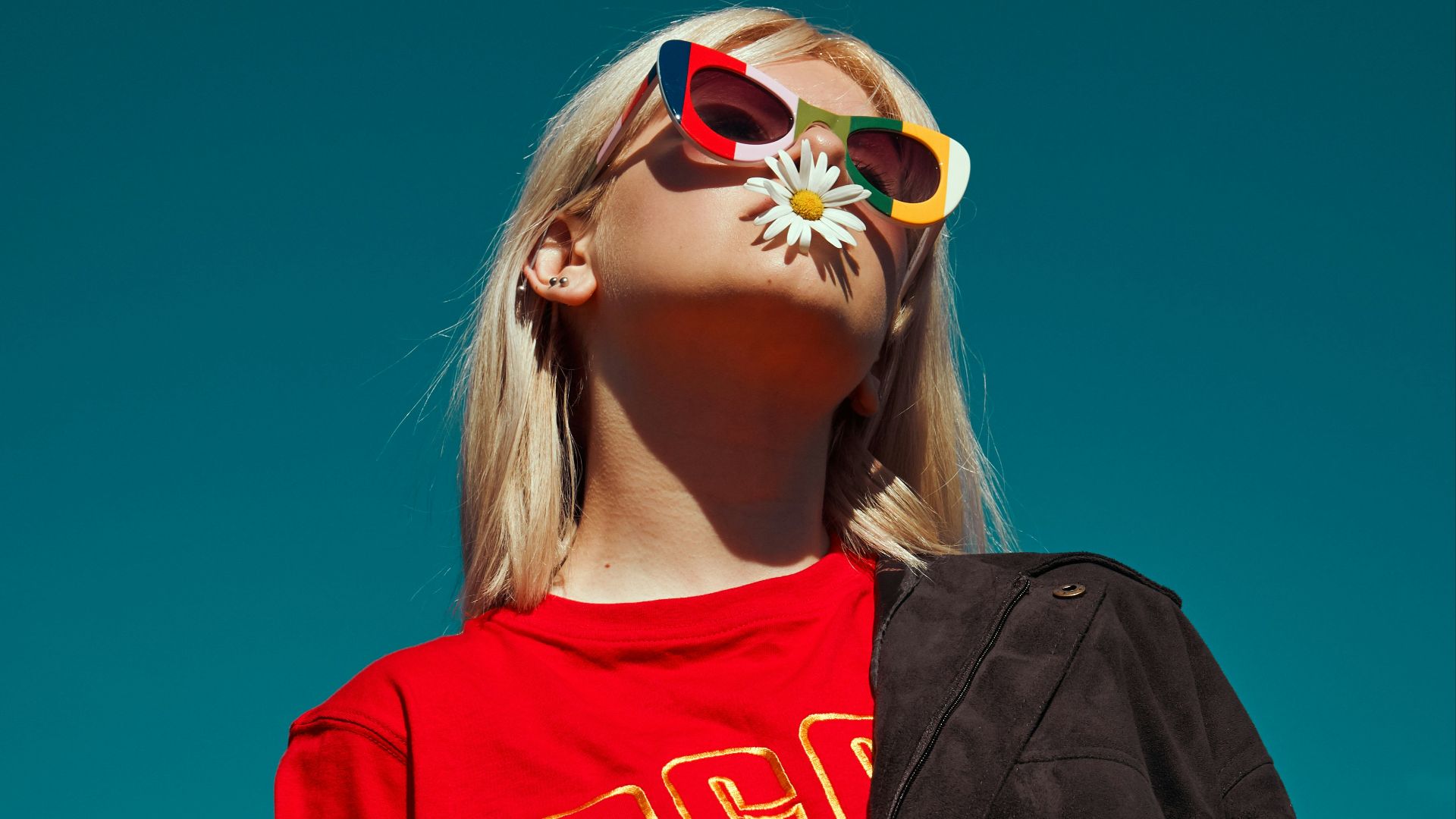 woman with sunglasses standing outdoor during daytime