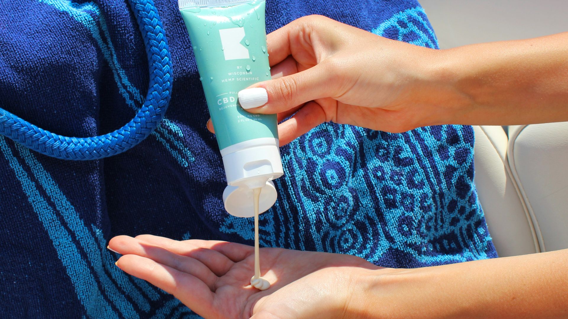 person holding white plastic tube bottle