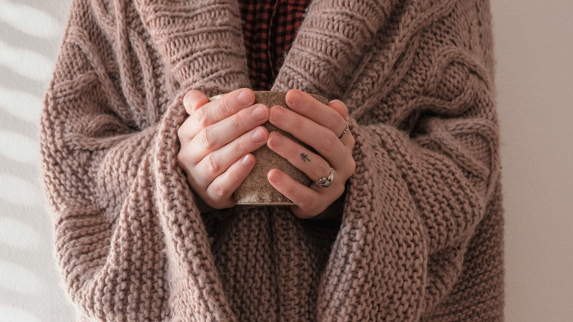 person in brown knit sweater