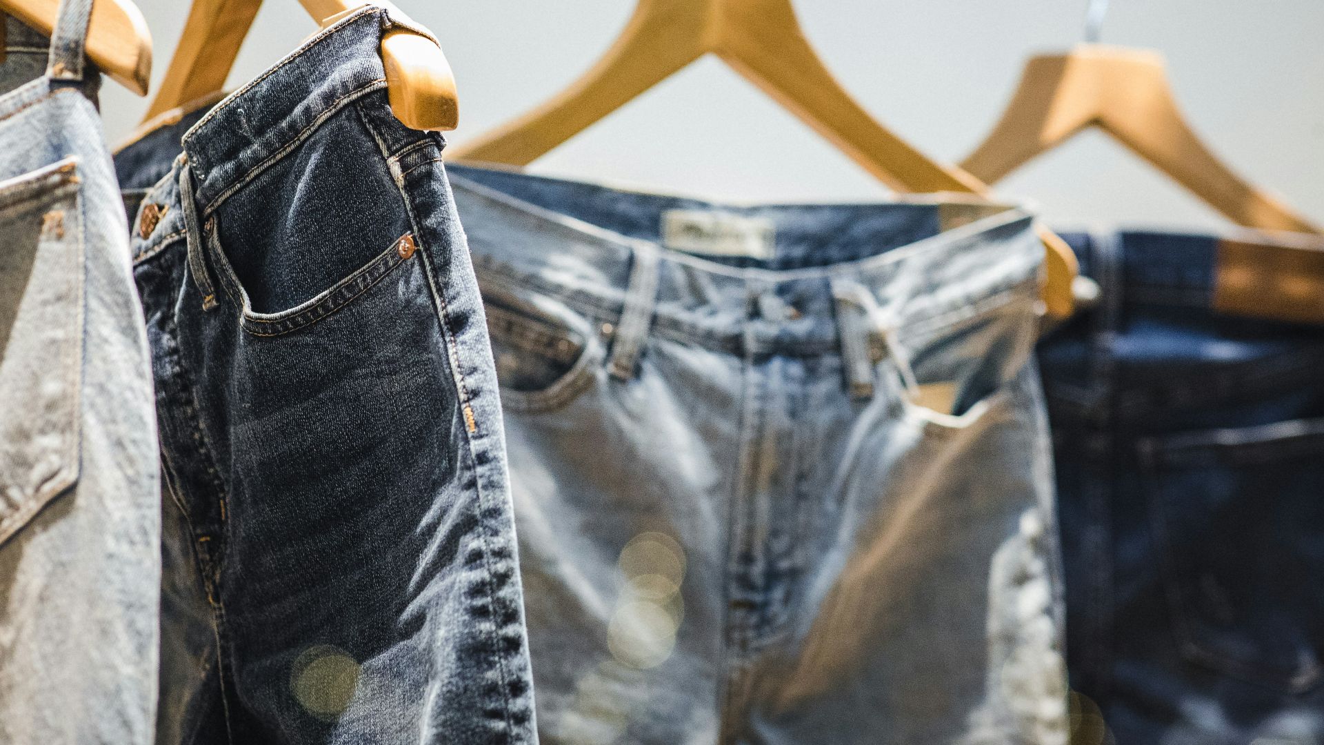 selective focus photography of hanged denim jeans