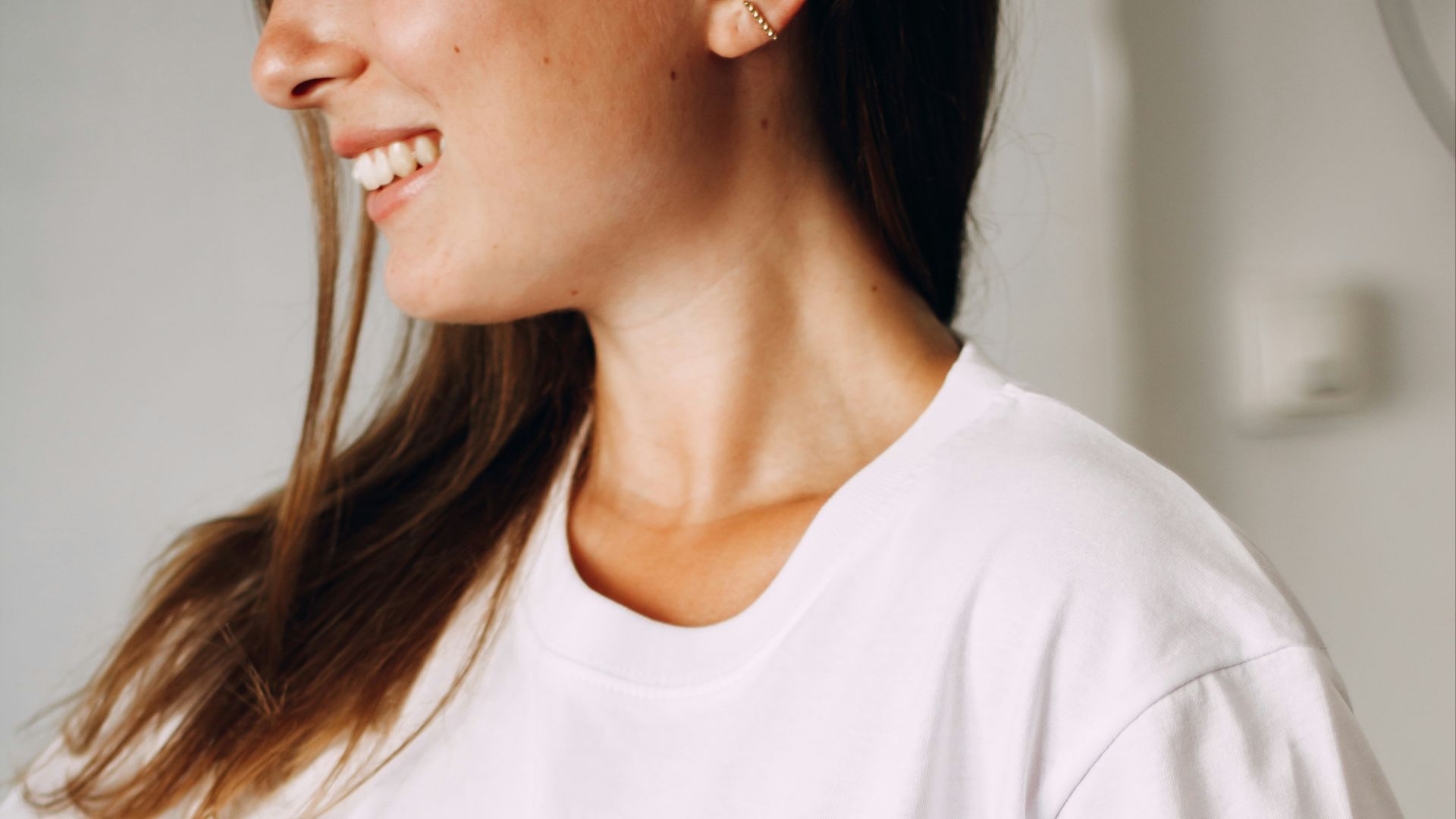a woman in a white shirt holding a cup of coffee