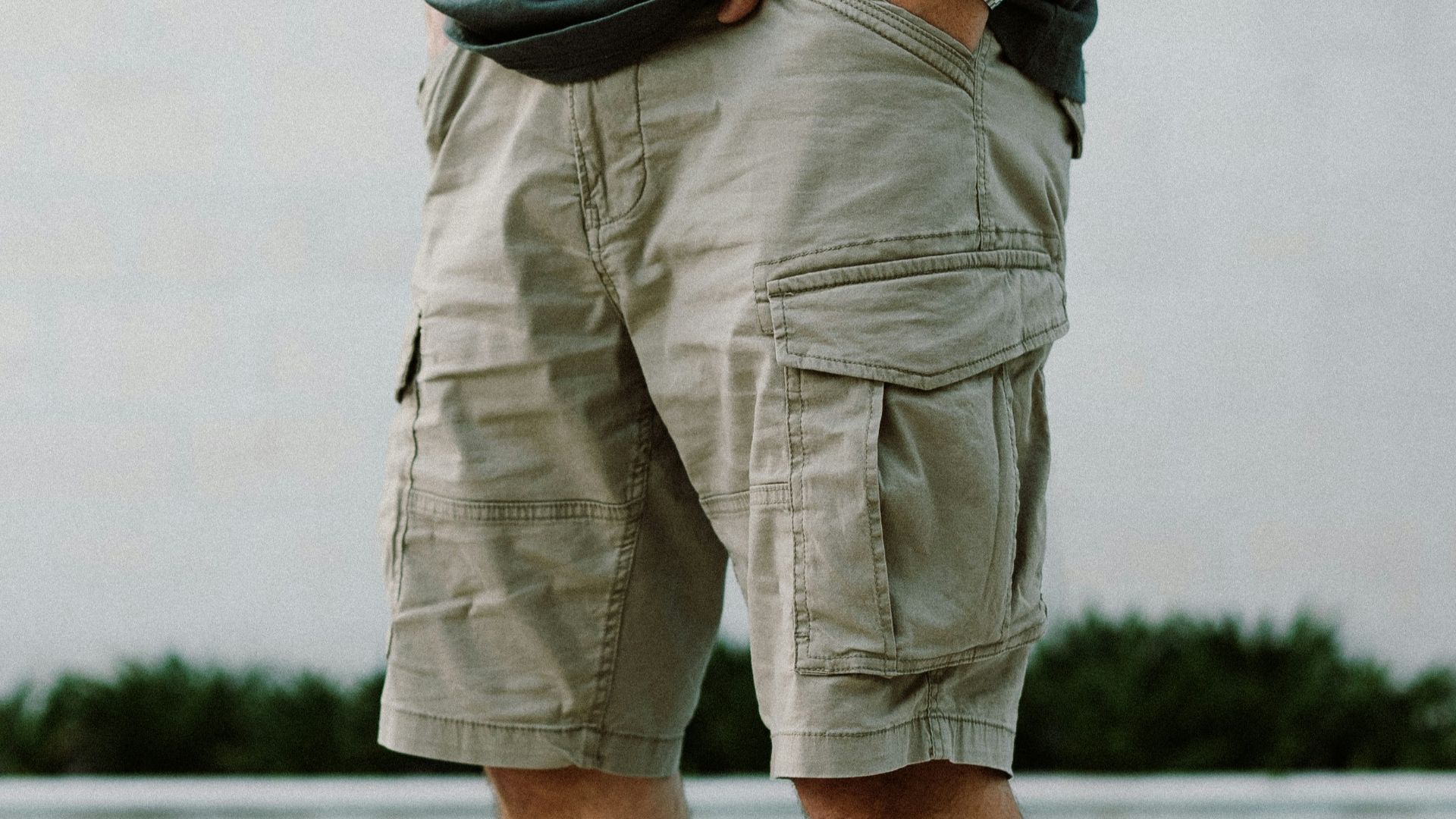 A man standing next to a swimming pool