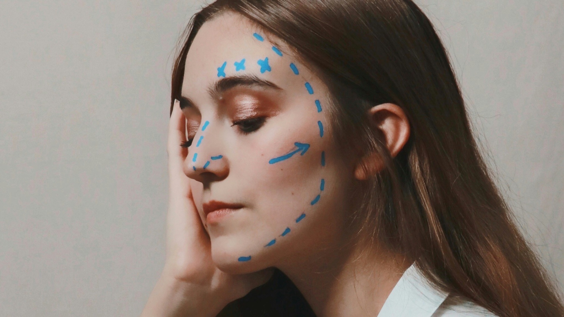 woman in white sleeveless shirt with blue eyes