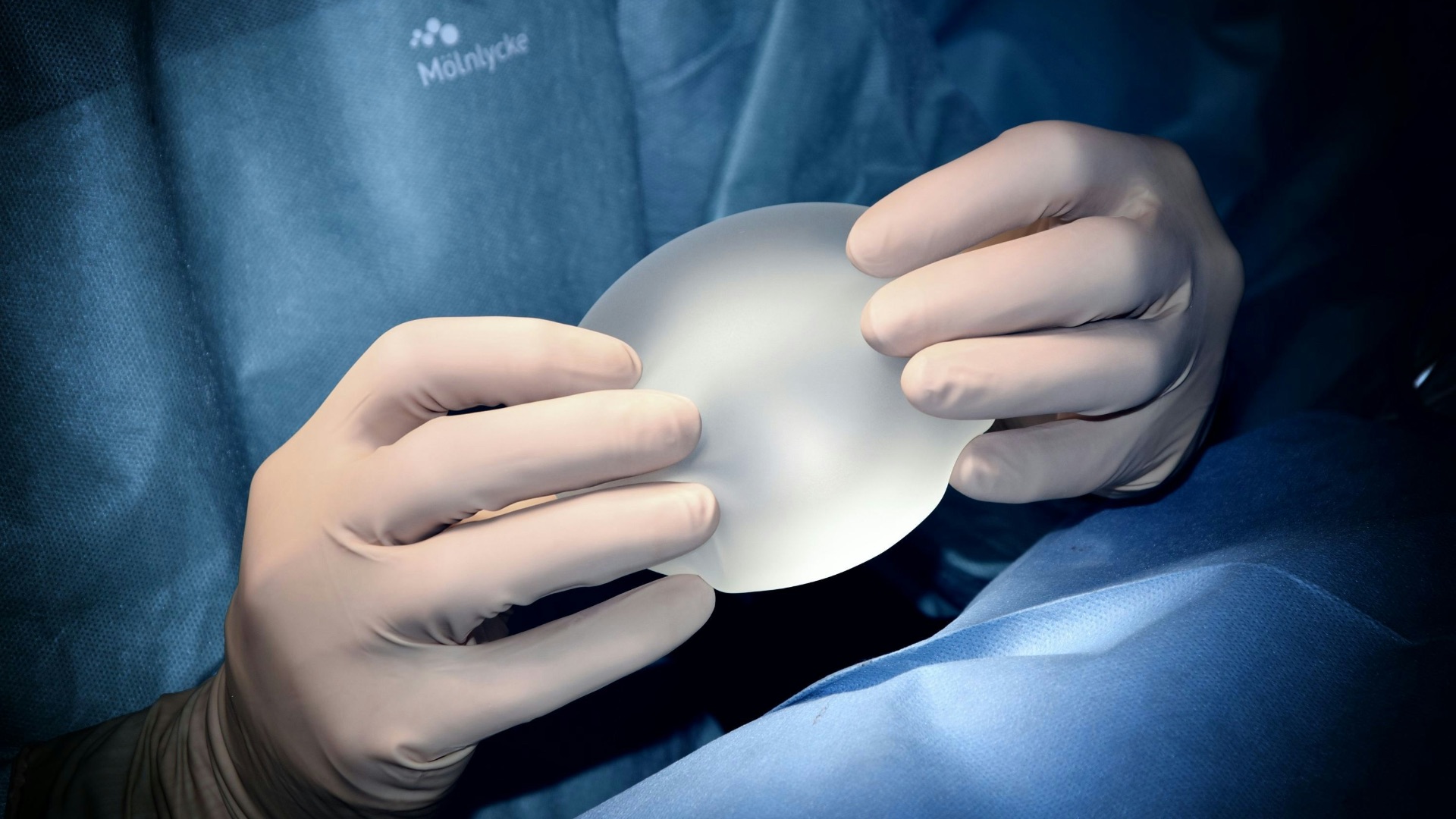 person holding white heart shaped ornament