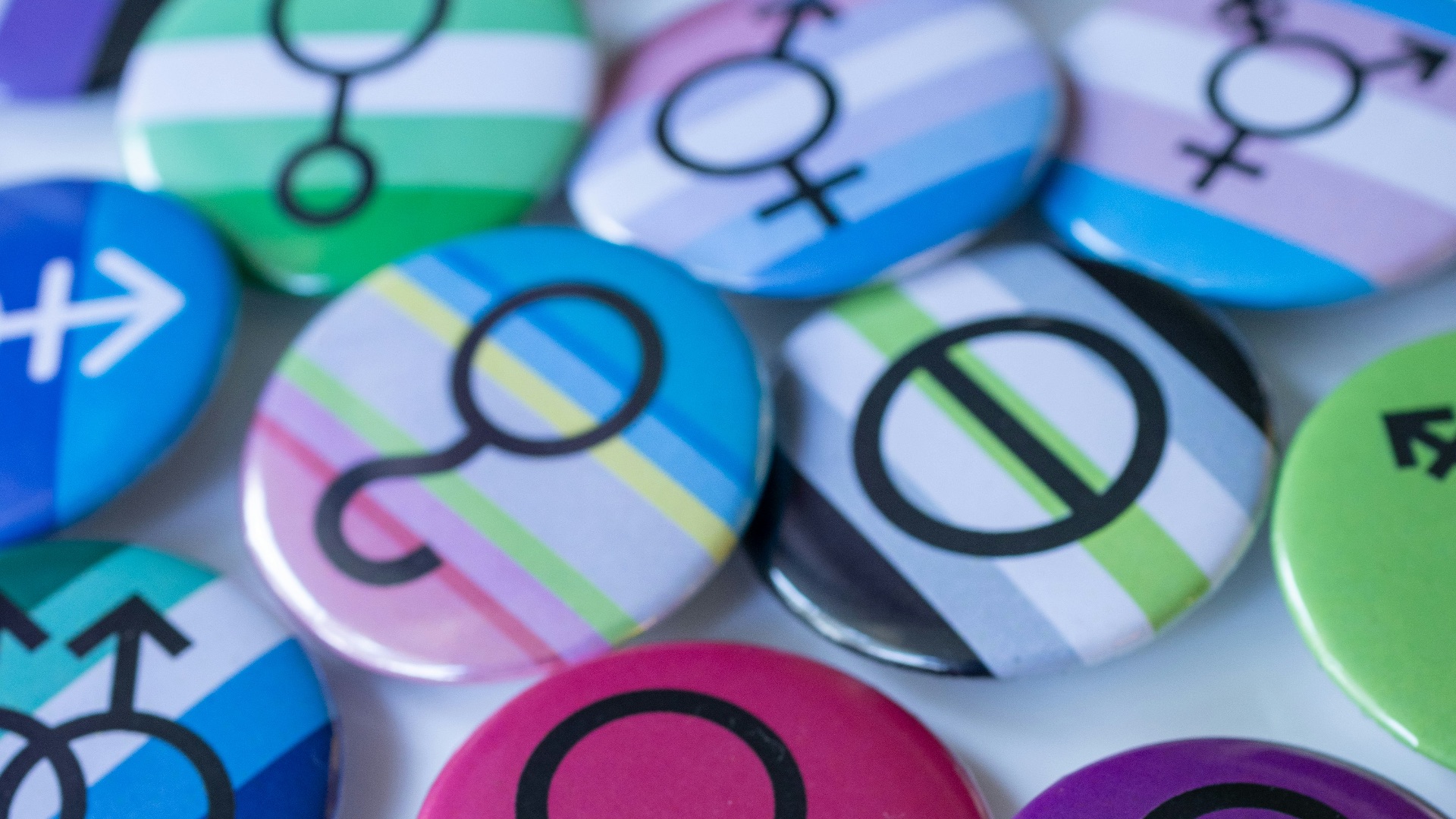 A pile of different colored and black and white buttons