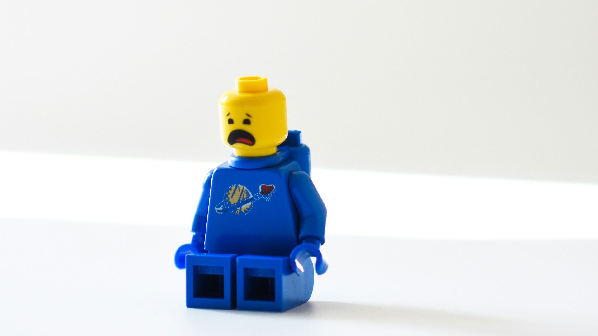 blue lego minifig on white surface